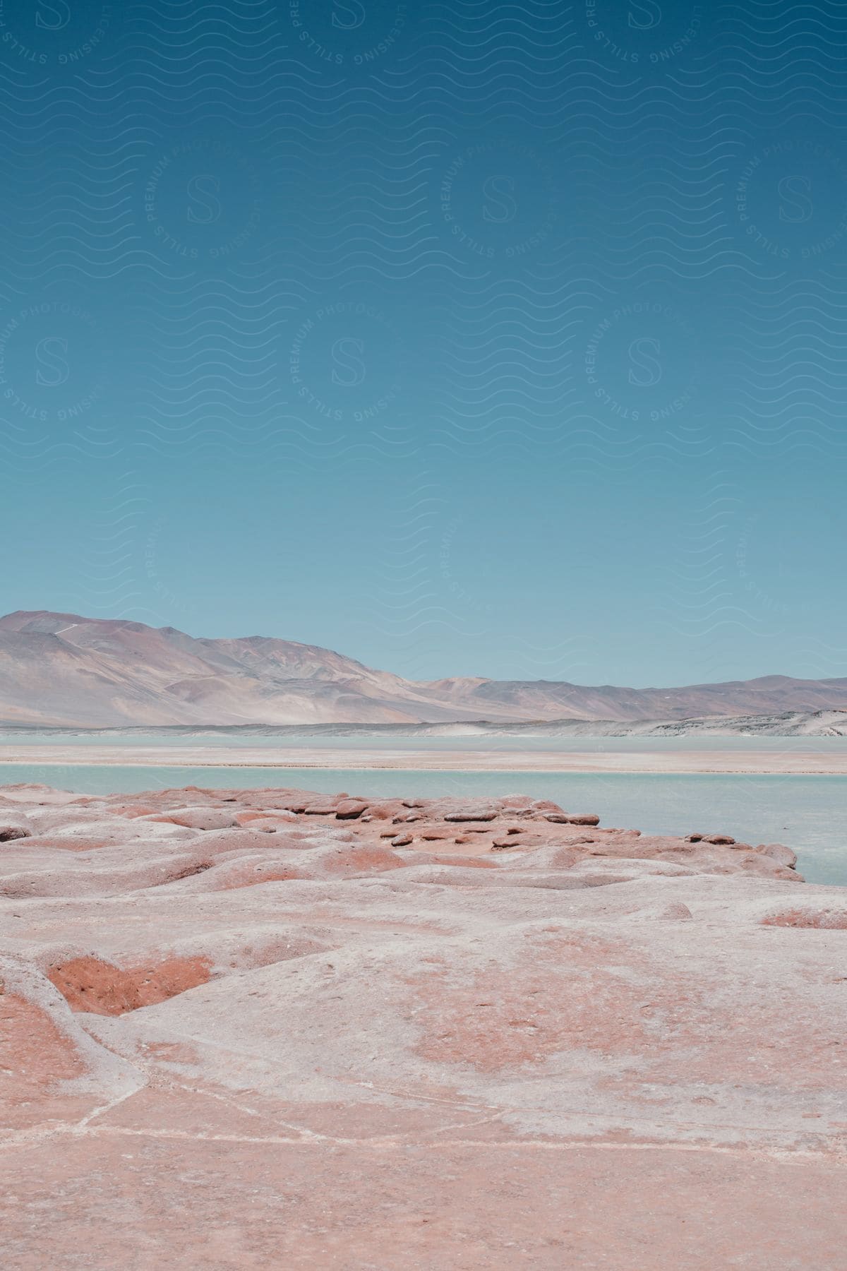 Lake In The Desert With Mountains And A Blue Sky