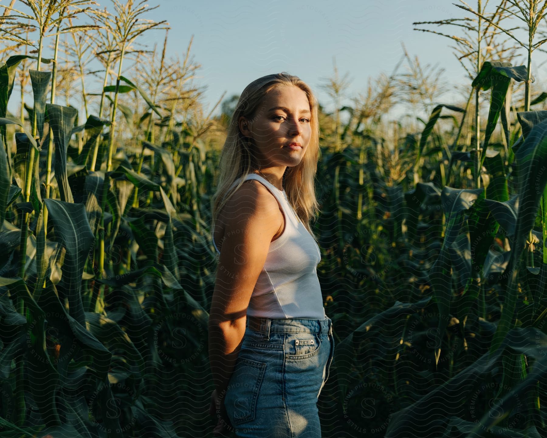A person with blonde hair is smiling in a field