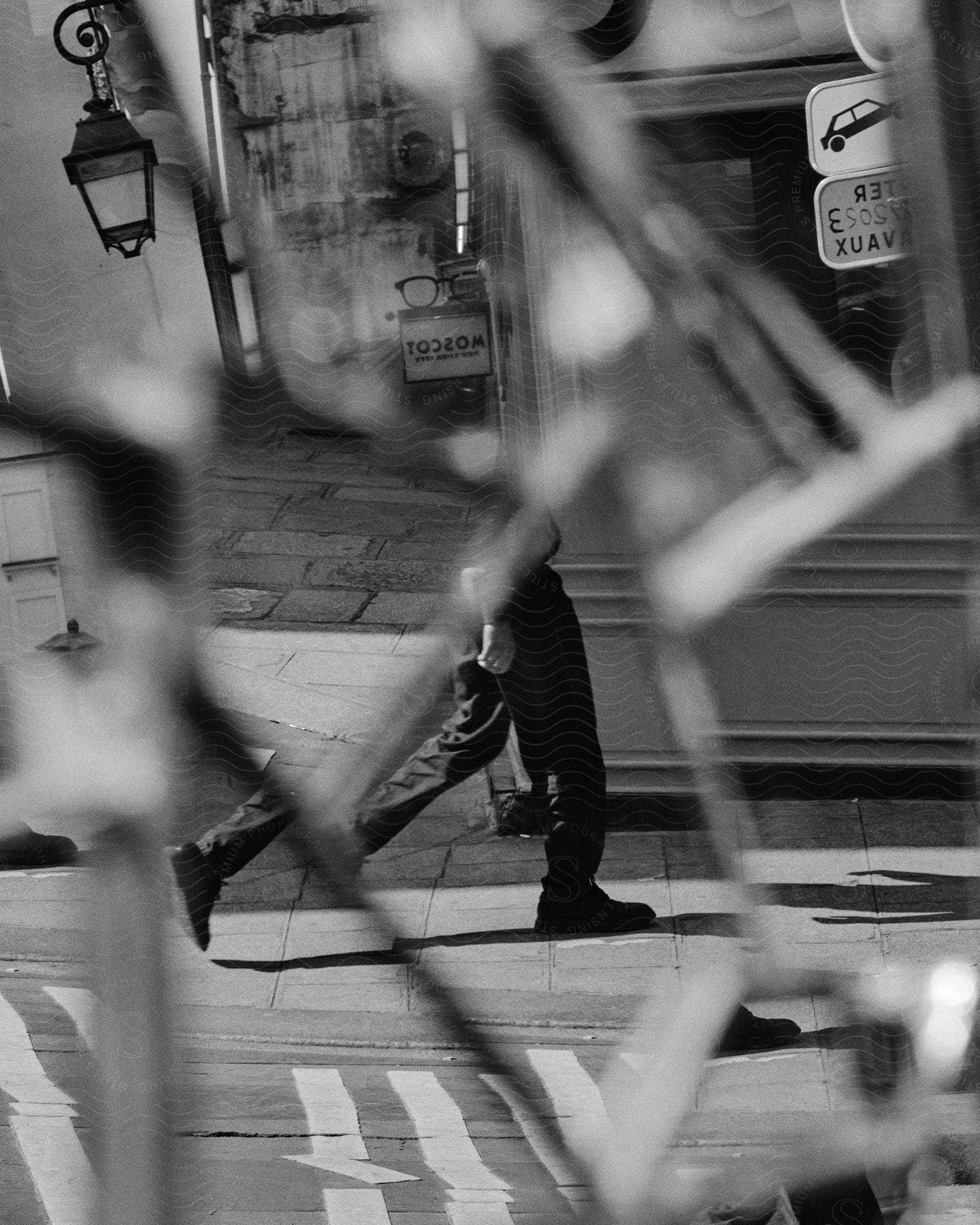 Man walking by a broken mirror reflecting partially