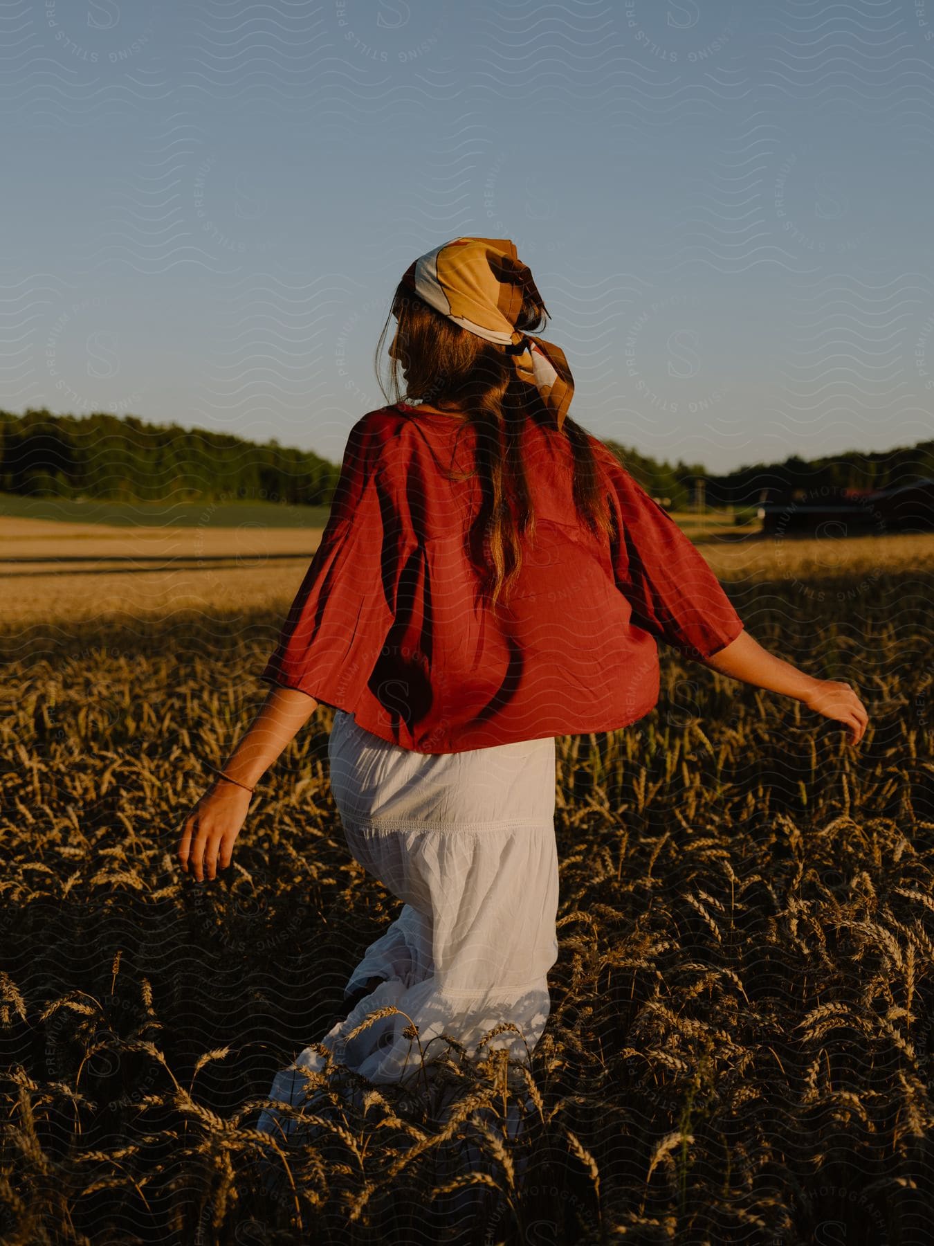 A Woman Walks In A Field With Overgrown Vegetation