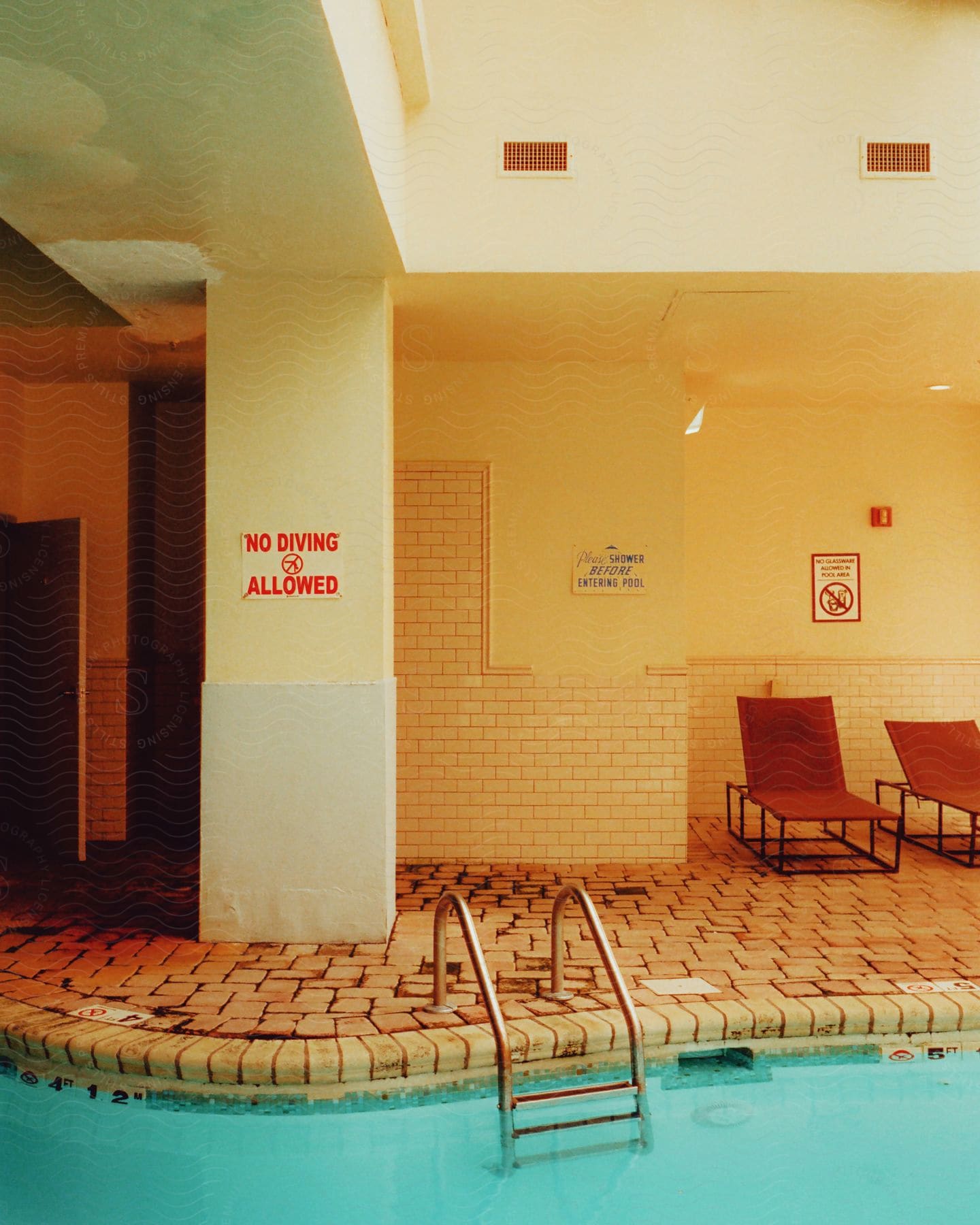 An indoor pool with a sign that says no diving