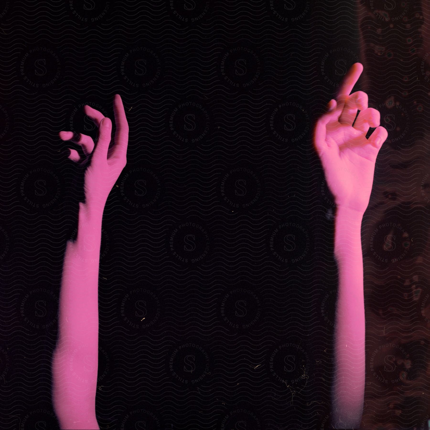 A womans hand with a purple nail and a thumb raised in a gesture