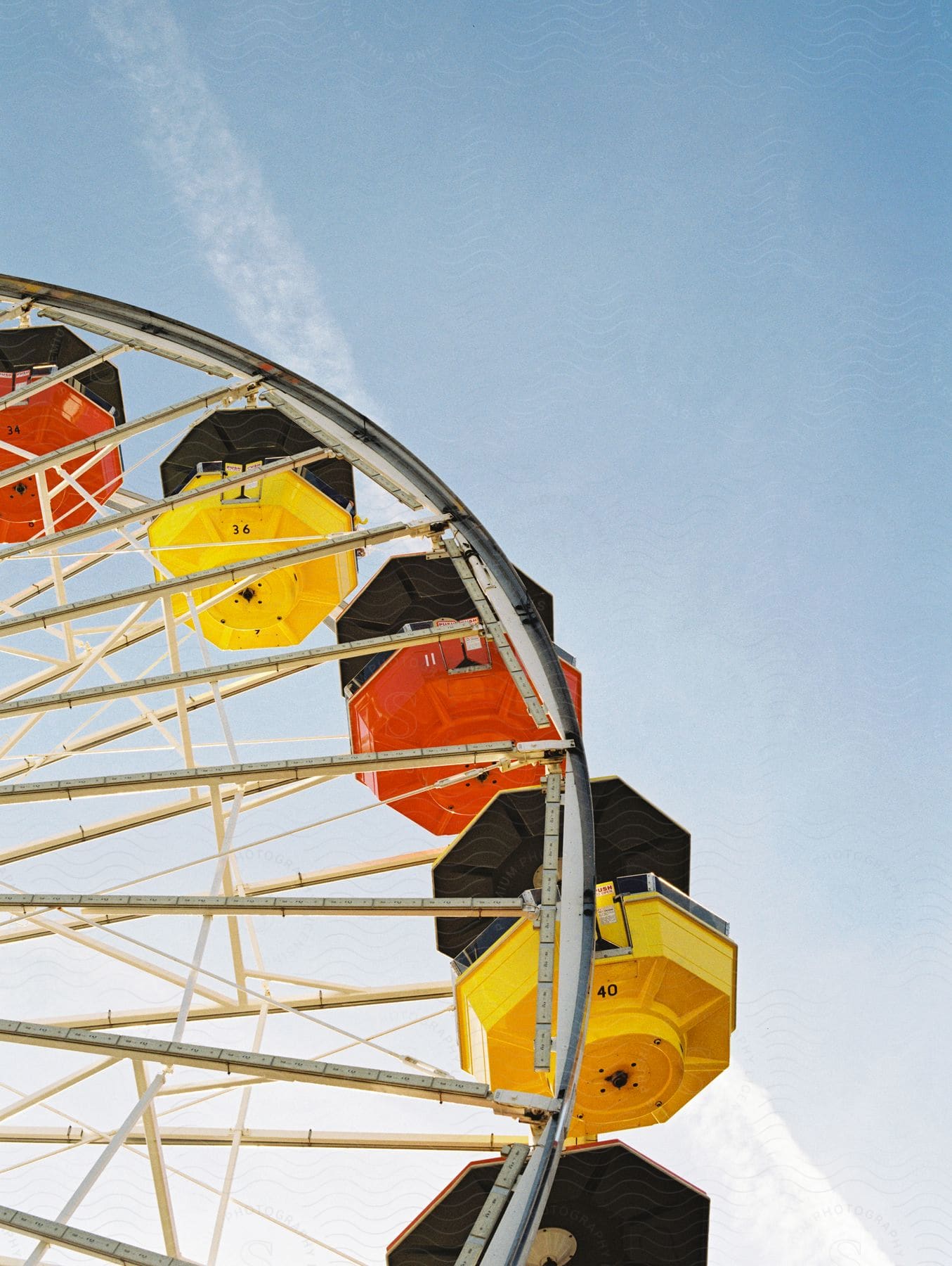 A ferris wheel against a cloudy sky at an amusement park