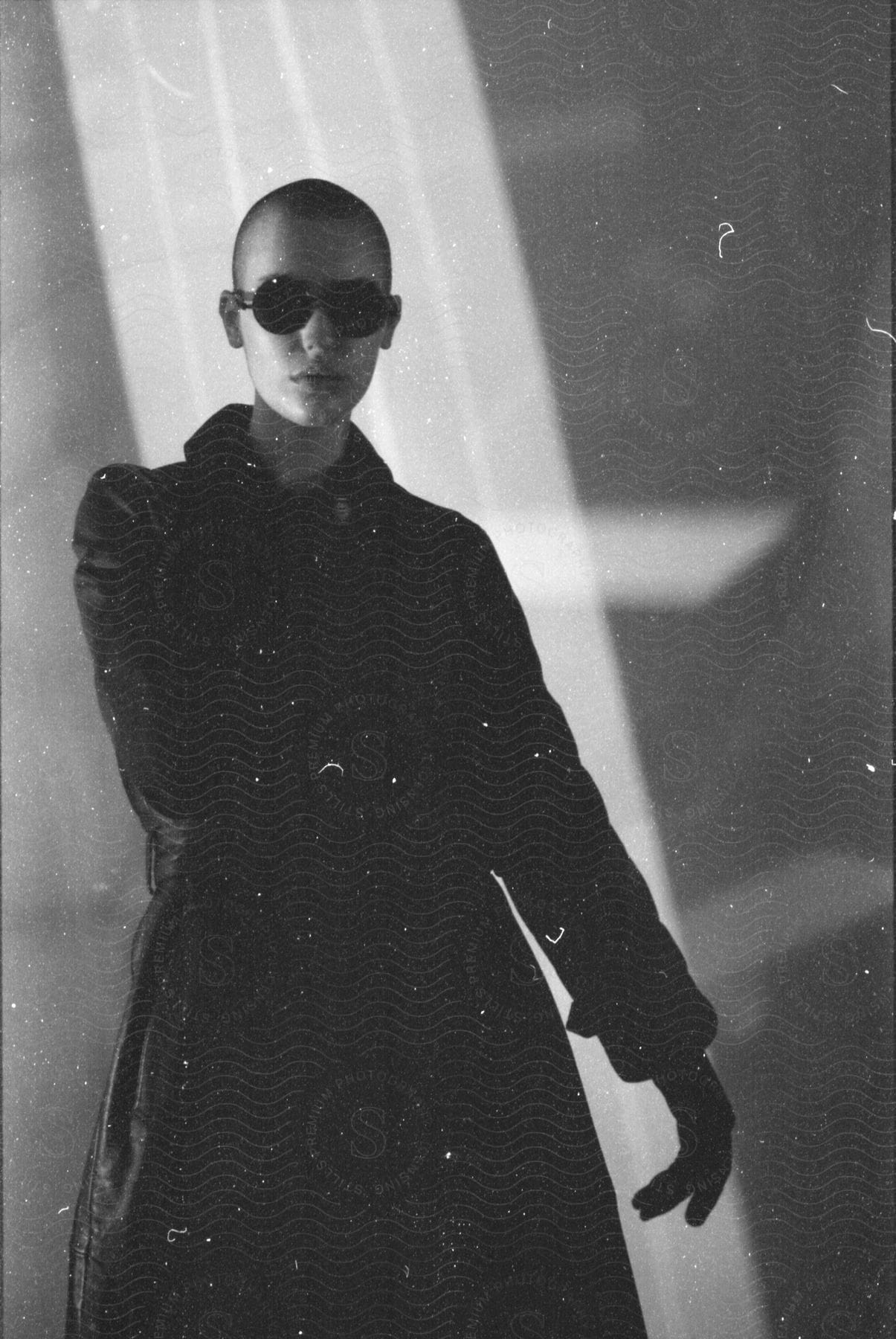 A young white woman wearing black clothes and sunglasses.