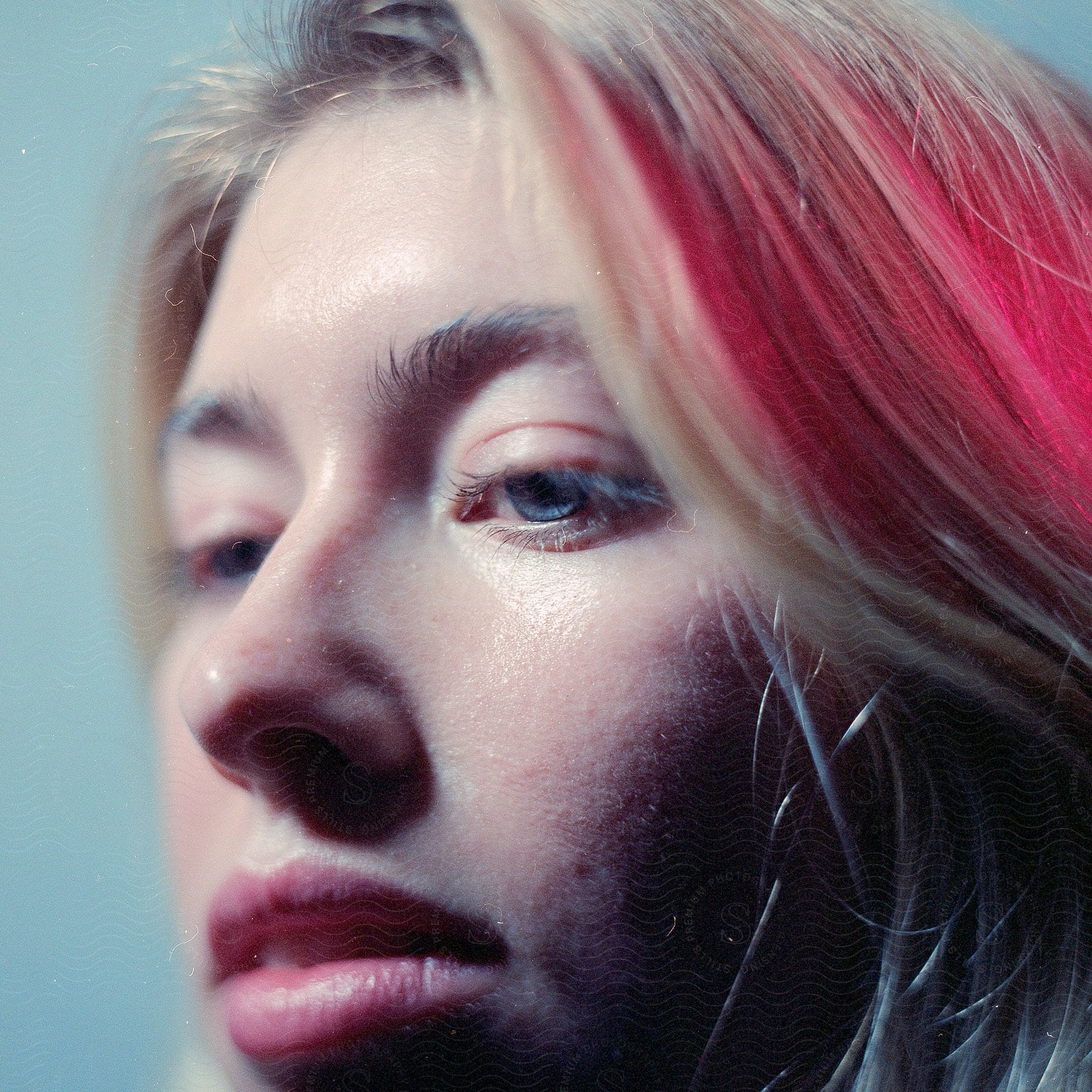 Close up of blonde woman’s face with blue eyes