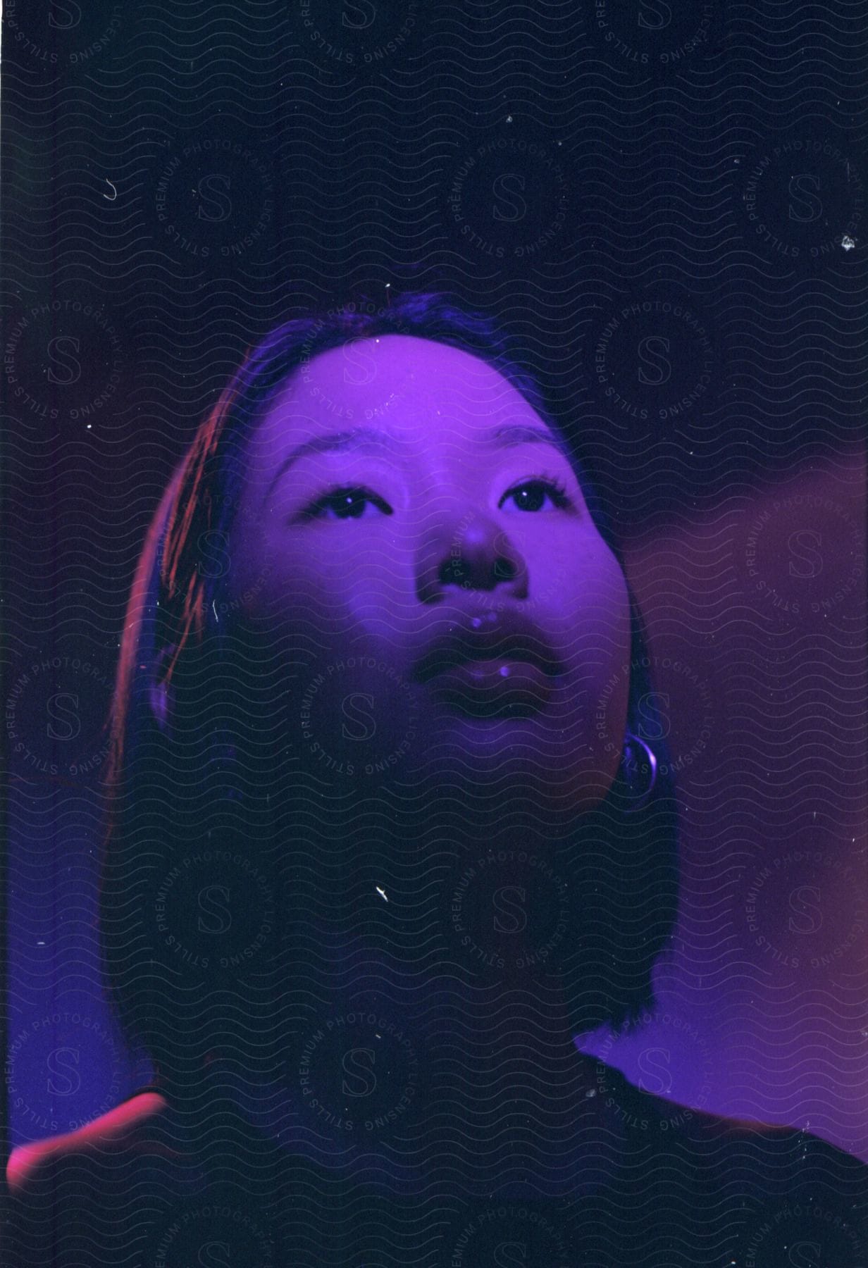 Close-up of a young woman's face during the starry night.