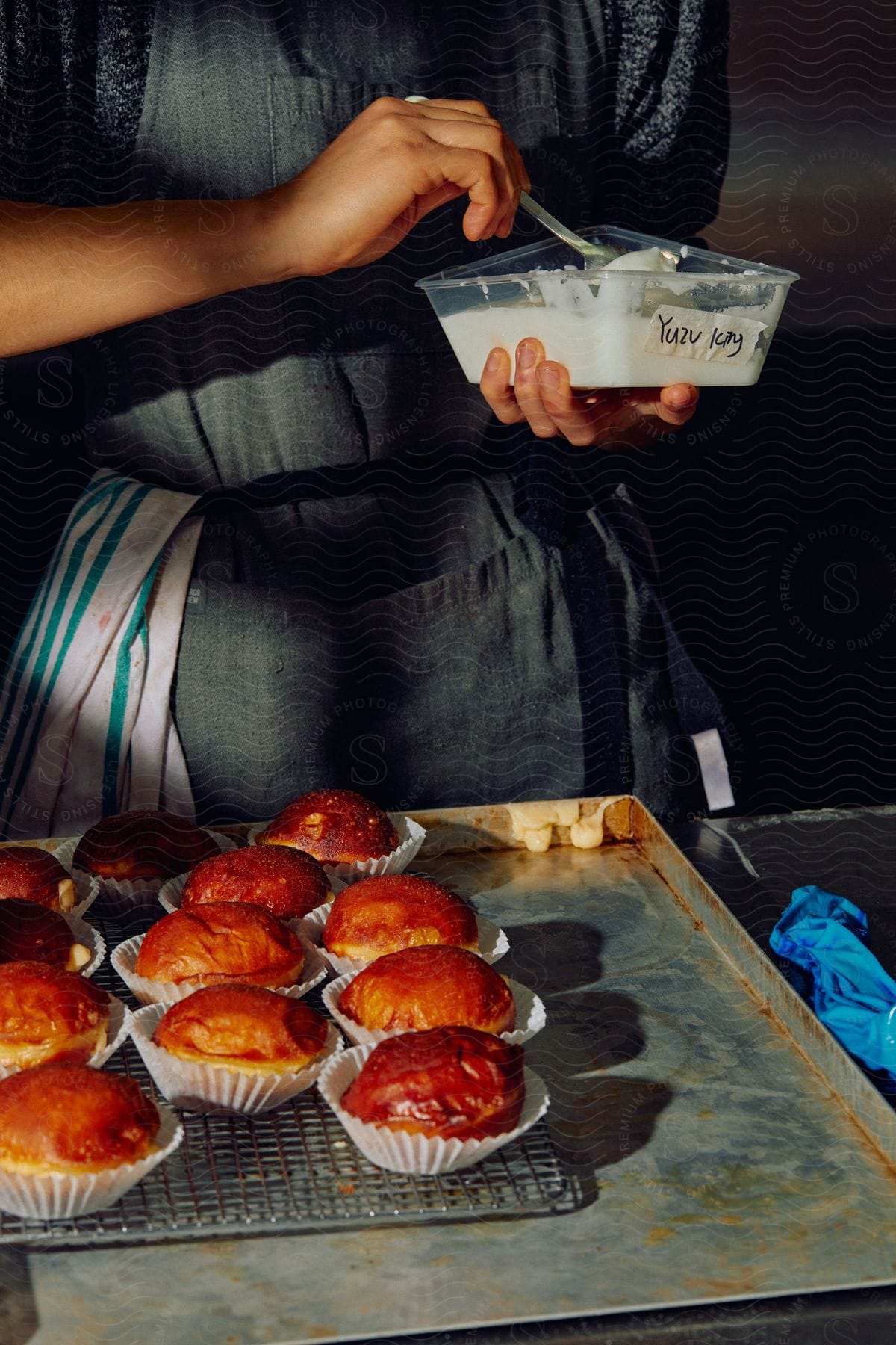 Stock photo of worker woman preparing baked goods in an industrial kitchen