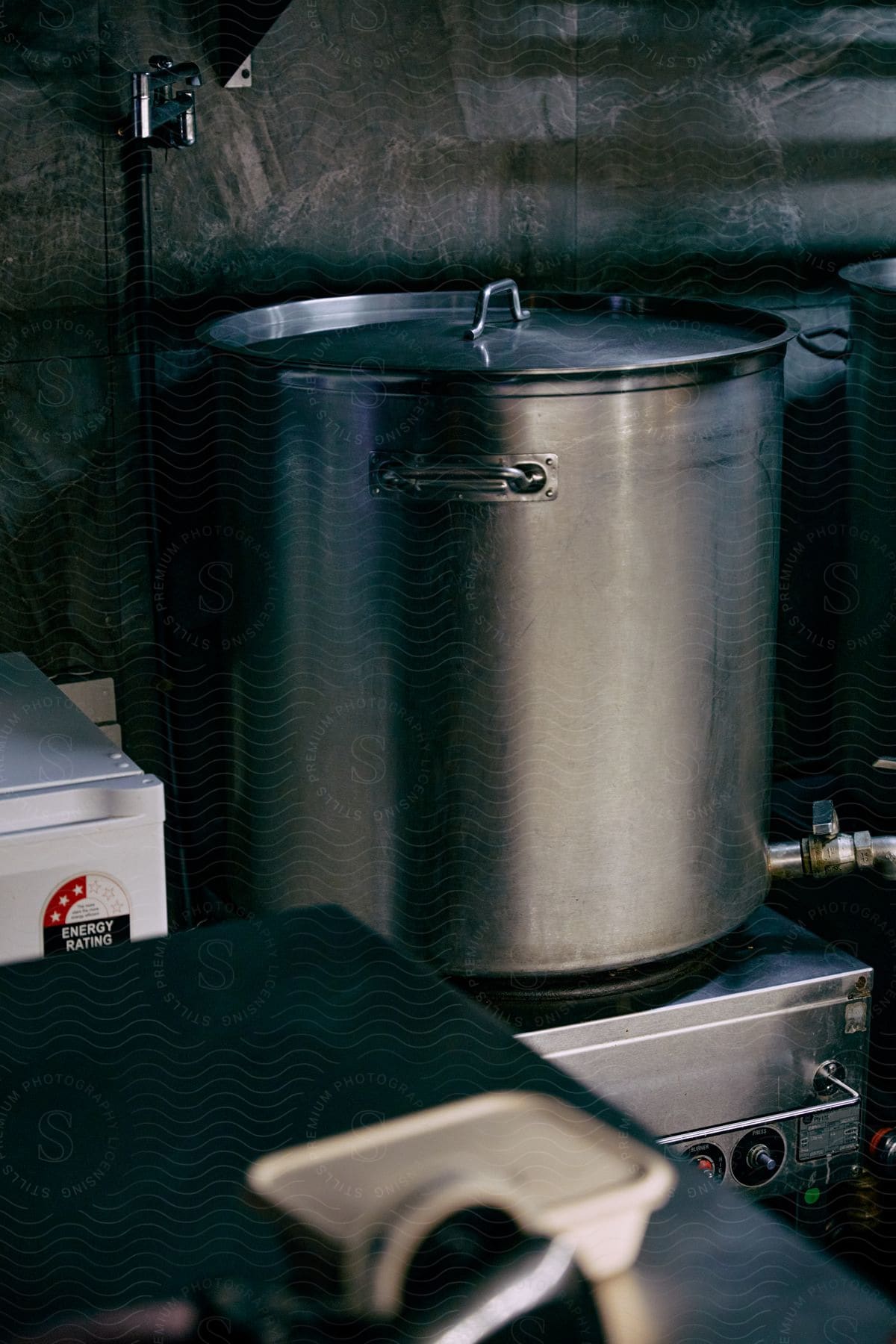 A pot is placed on a gas stove in a welllit room indicating the preparation of a delicious meal