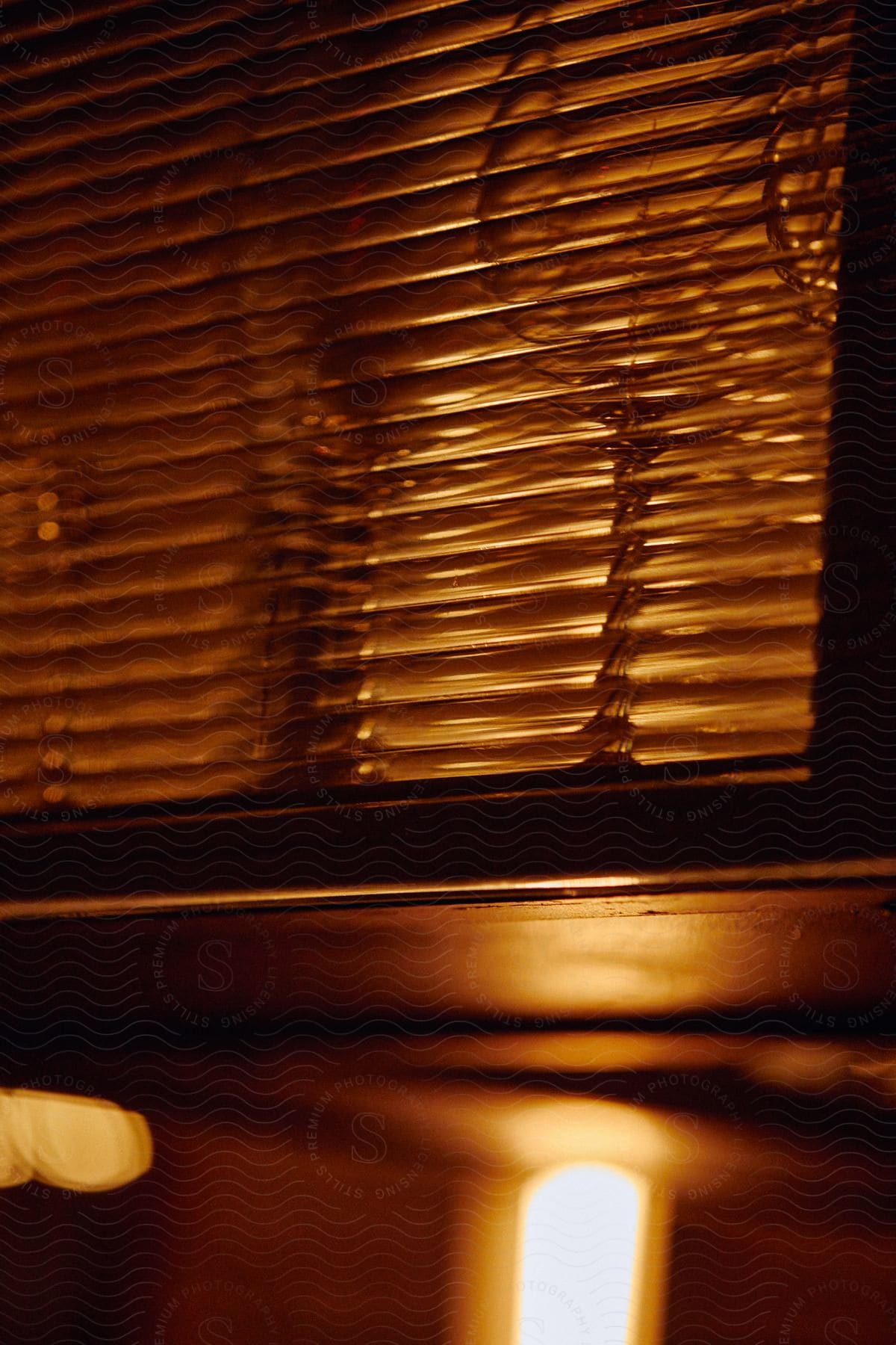 Close up of a sunbeam shining through window blinds in an interior setting