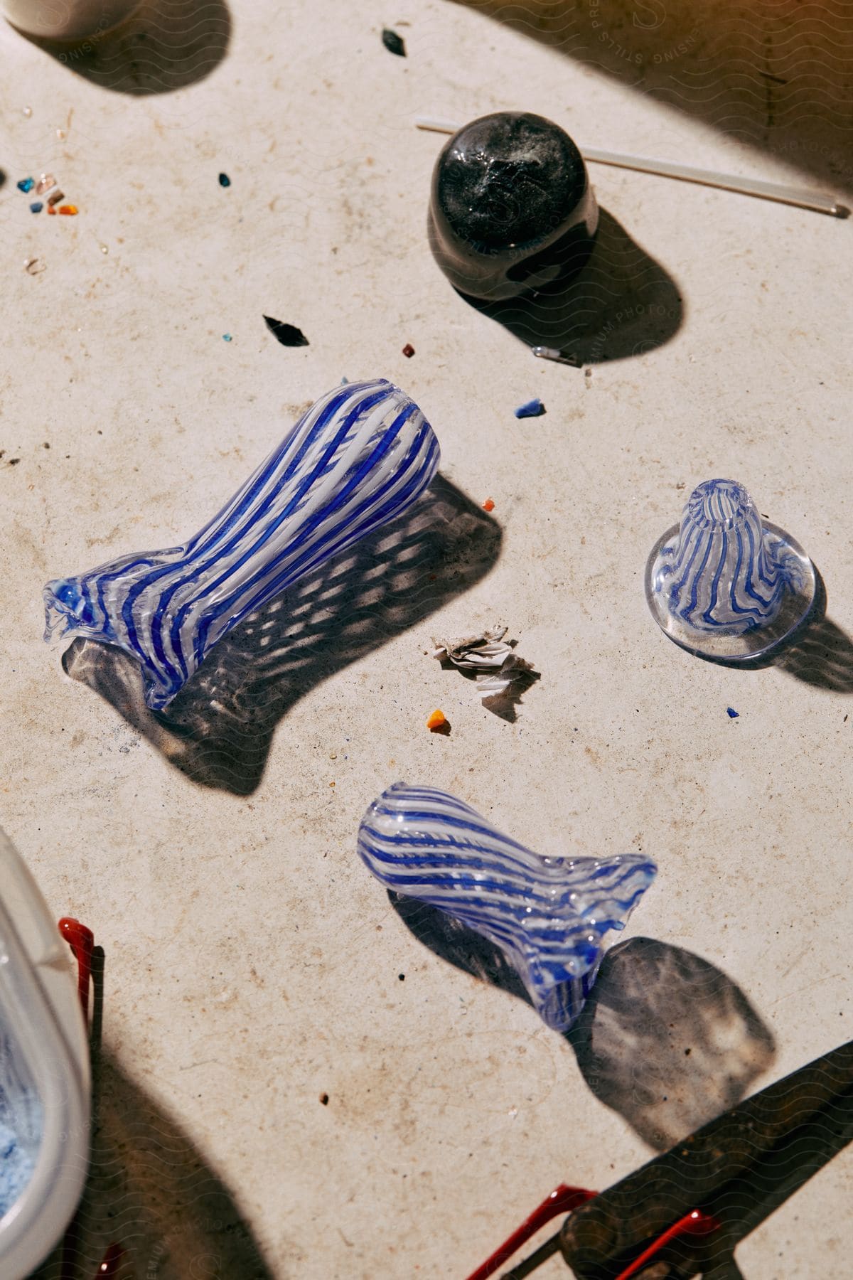 Blue and white glass sculptures resting on a table