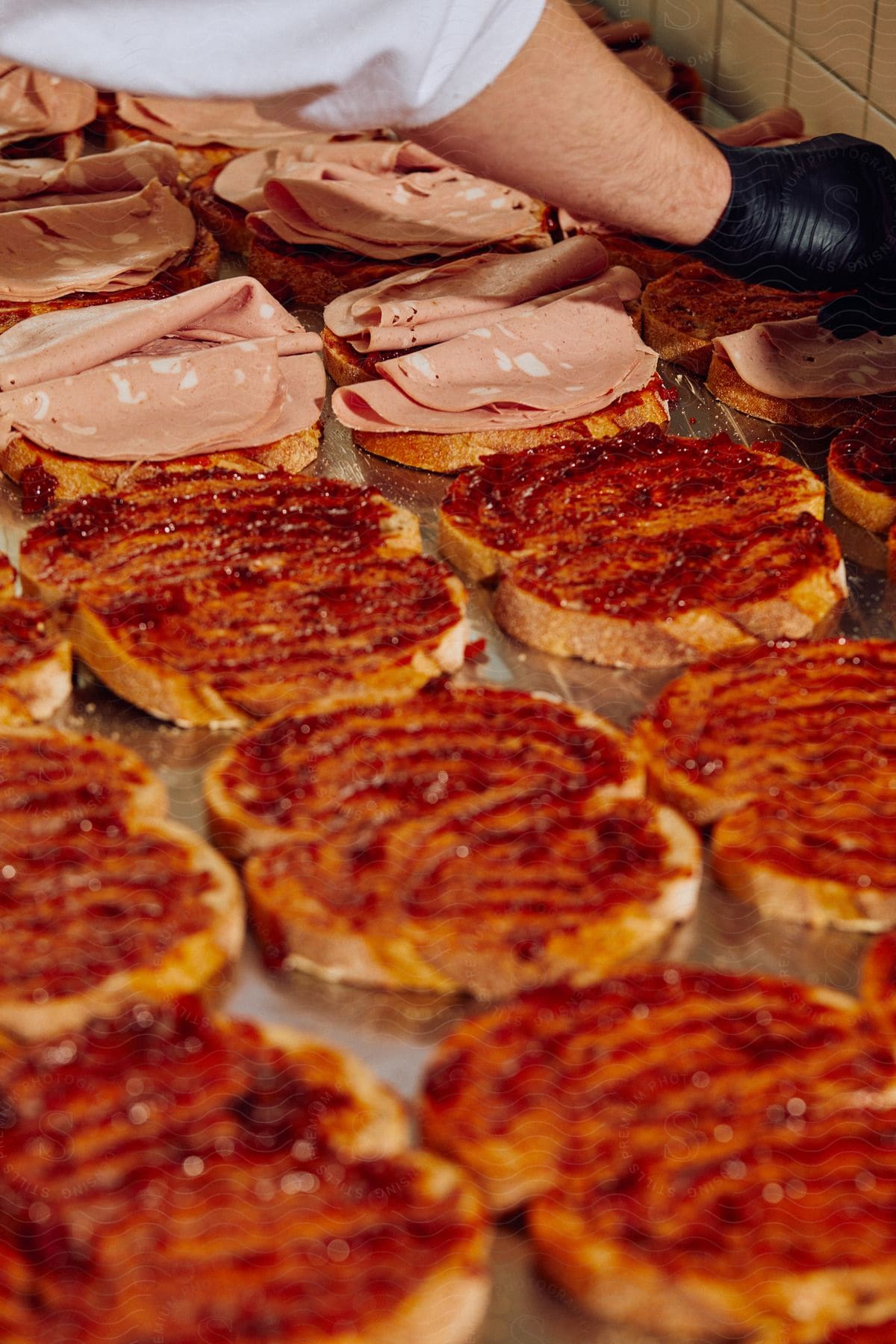 Stock photo of chef assembling sandwiches on restaurant kitchen countertop