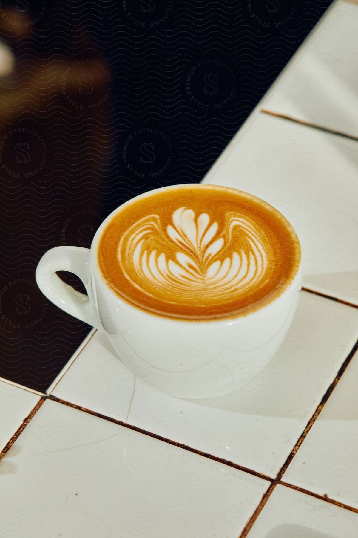 A steaming mug of tea sits gracefully on a white table inviting relaxation and solace