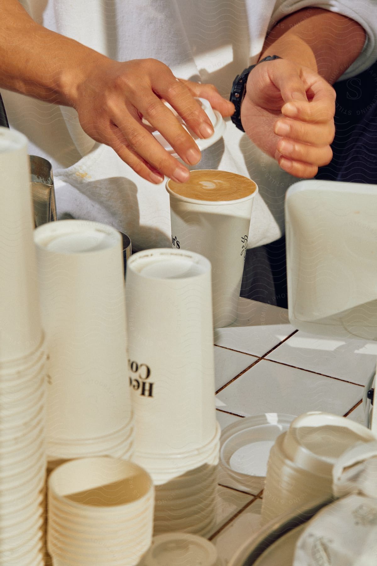 Persons hands holding a large cup of coffee latte