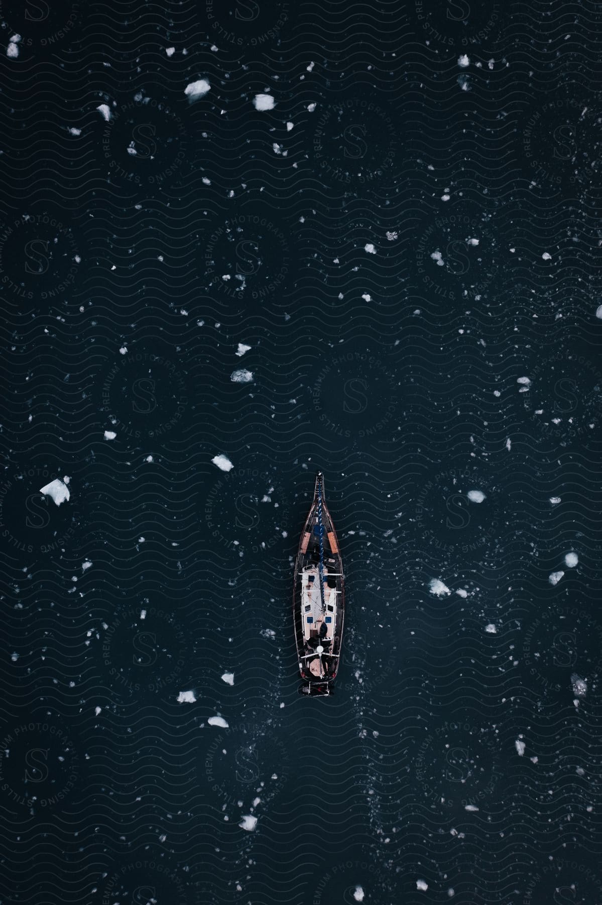 A Boat Sails Through Icy Waters With Small Pieces Of Ice Floating On The Surface