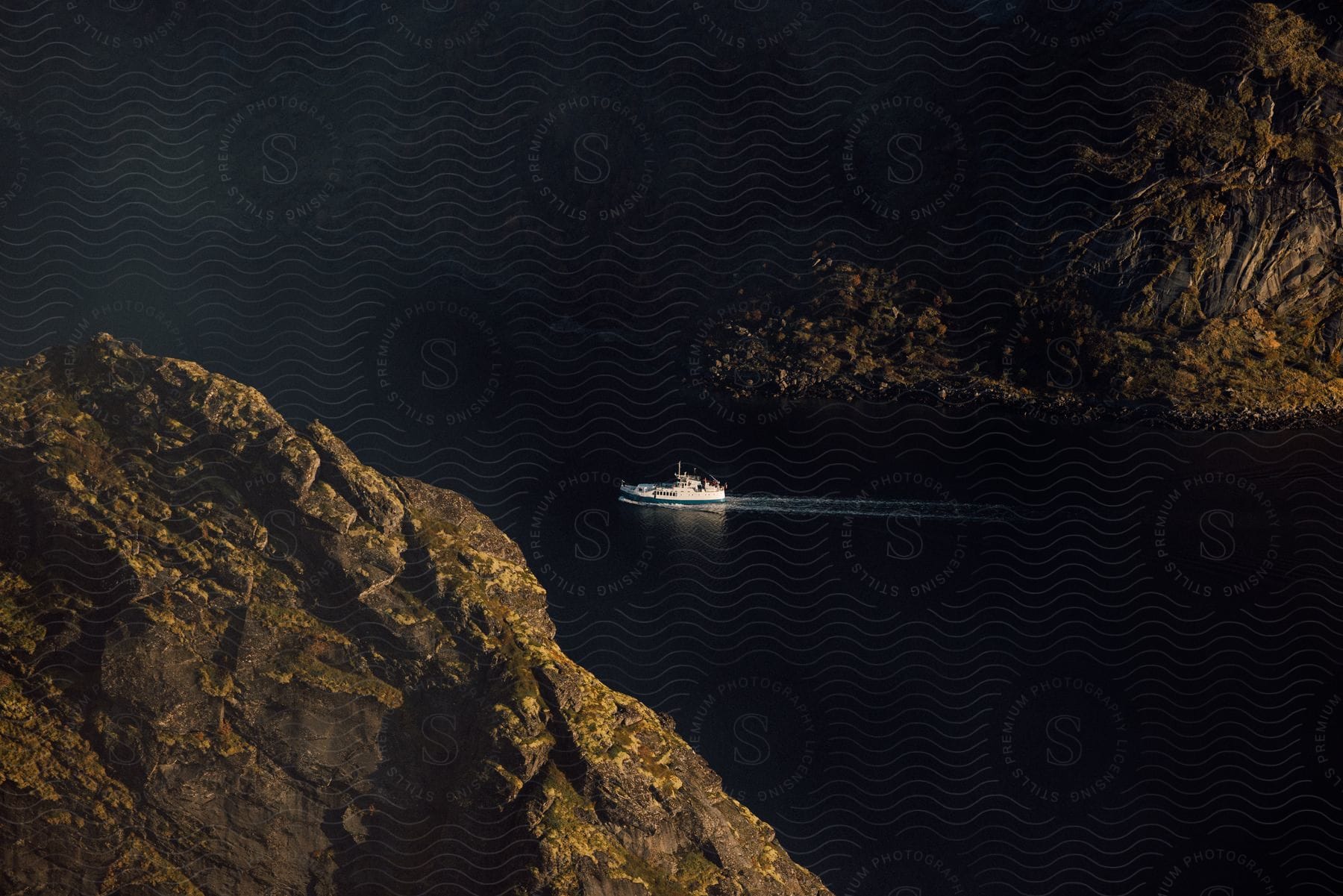 Boat crossing between two rocky mountains in the outdoors