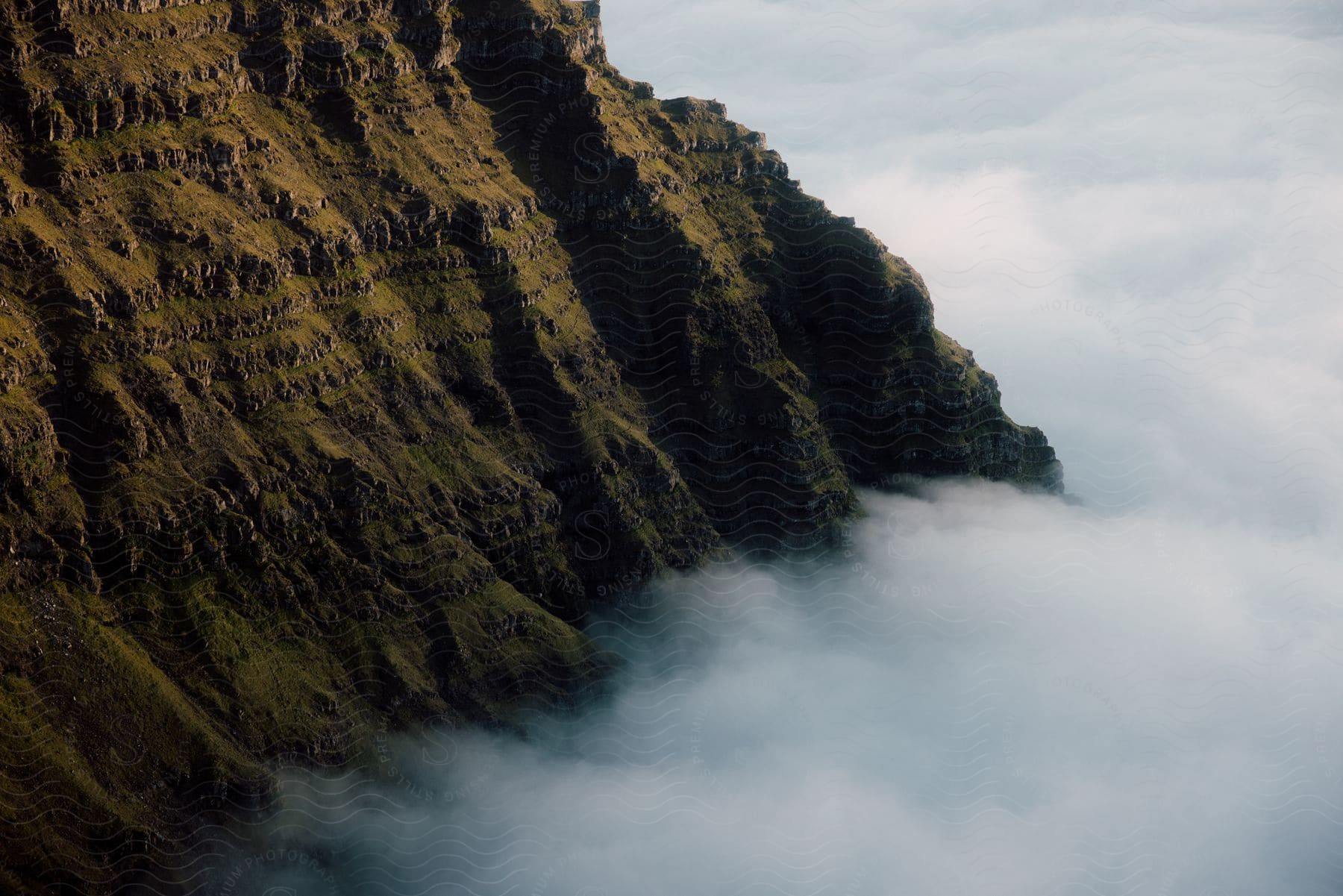 A High Peak Above A Cloudline In The Outdoors During The Day