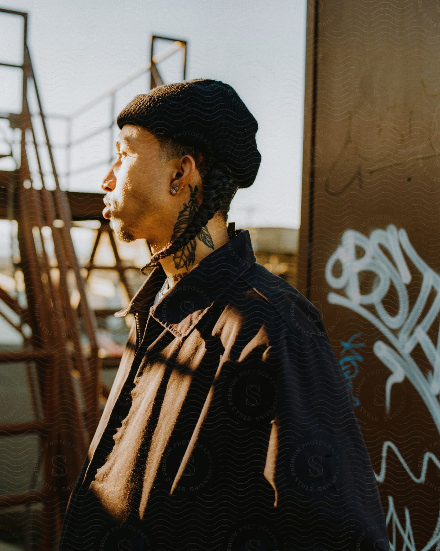 A man standing outside by a wall