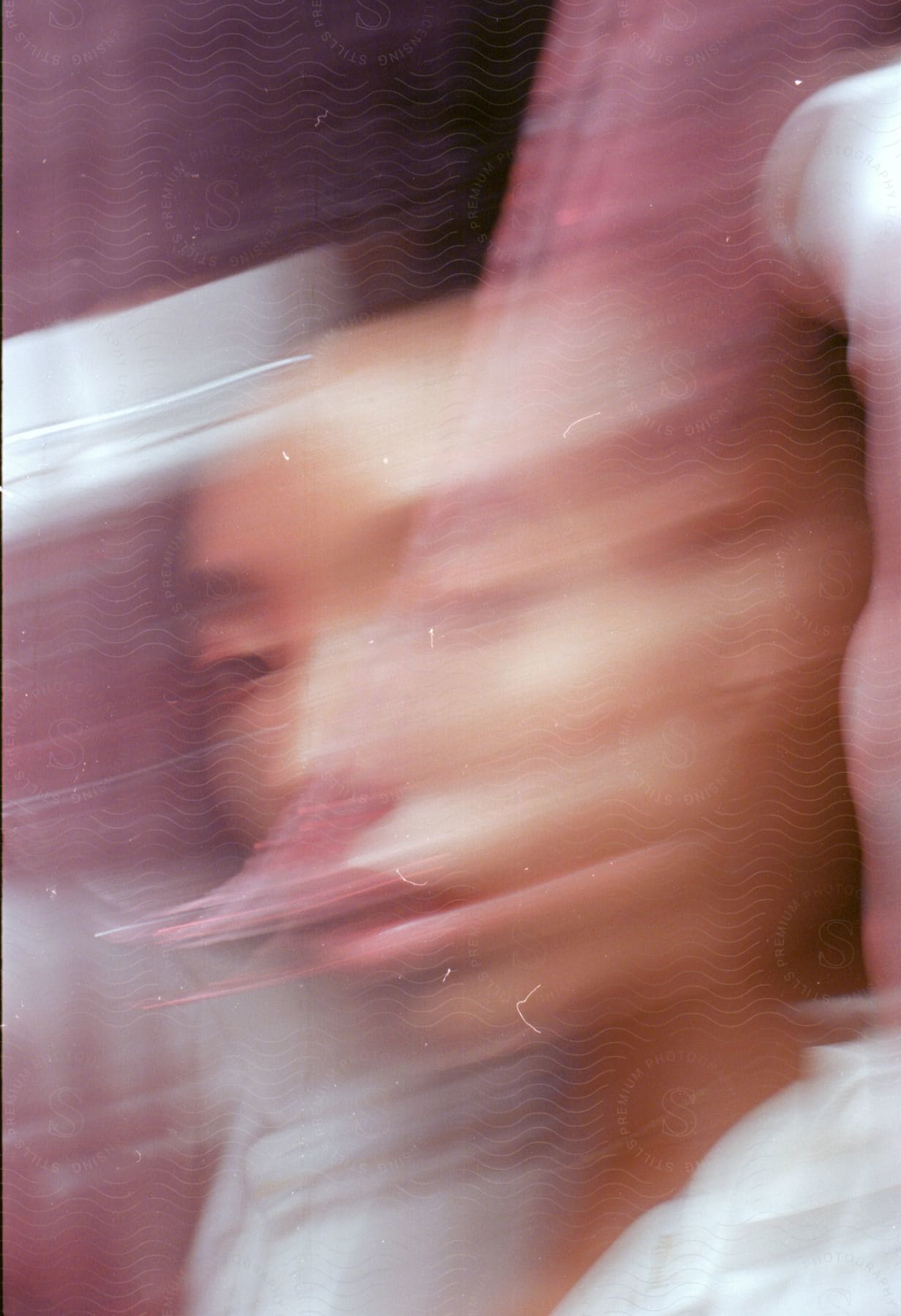 Asian woman wearing white with distorted face due to motion blur