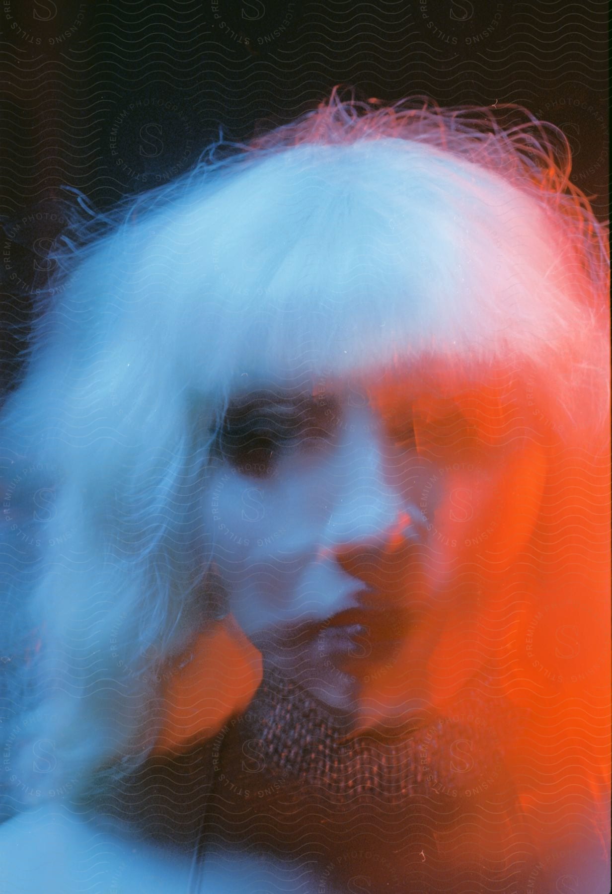 A young girl wearing a white wig with a slight double exposure