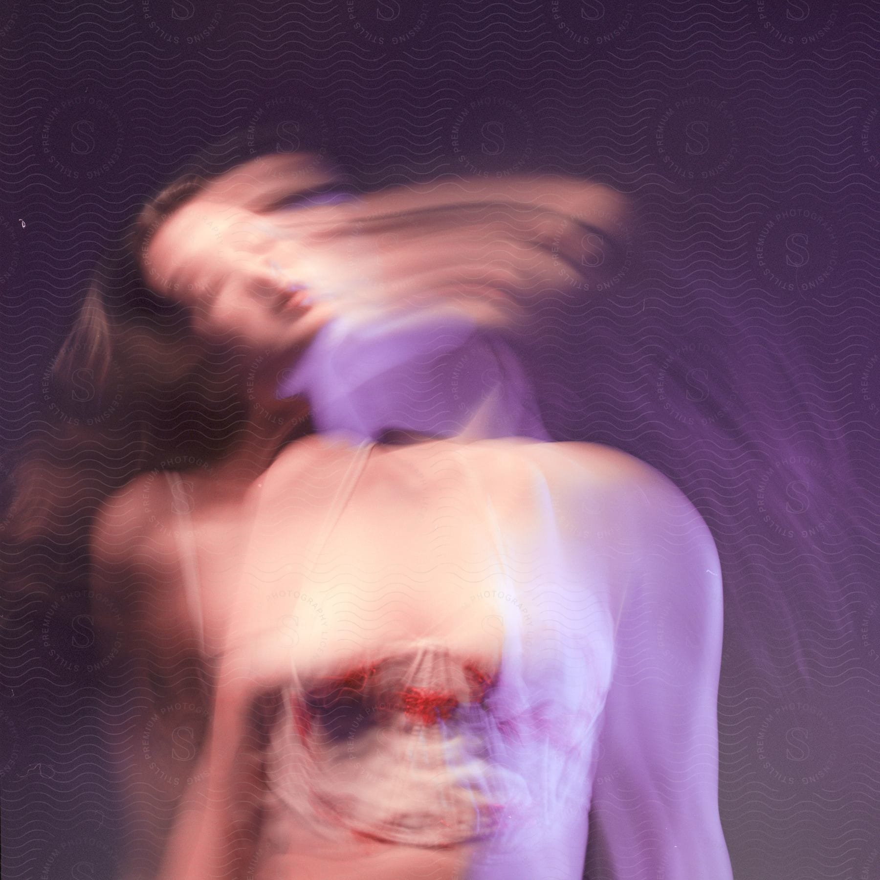 Blurred close up of a young womans body in motion leaving trails