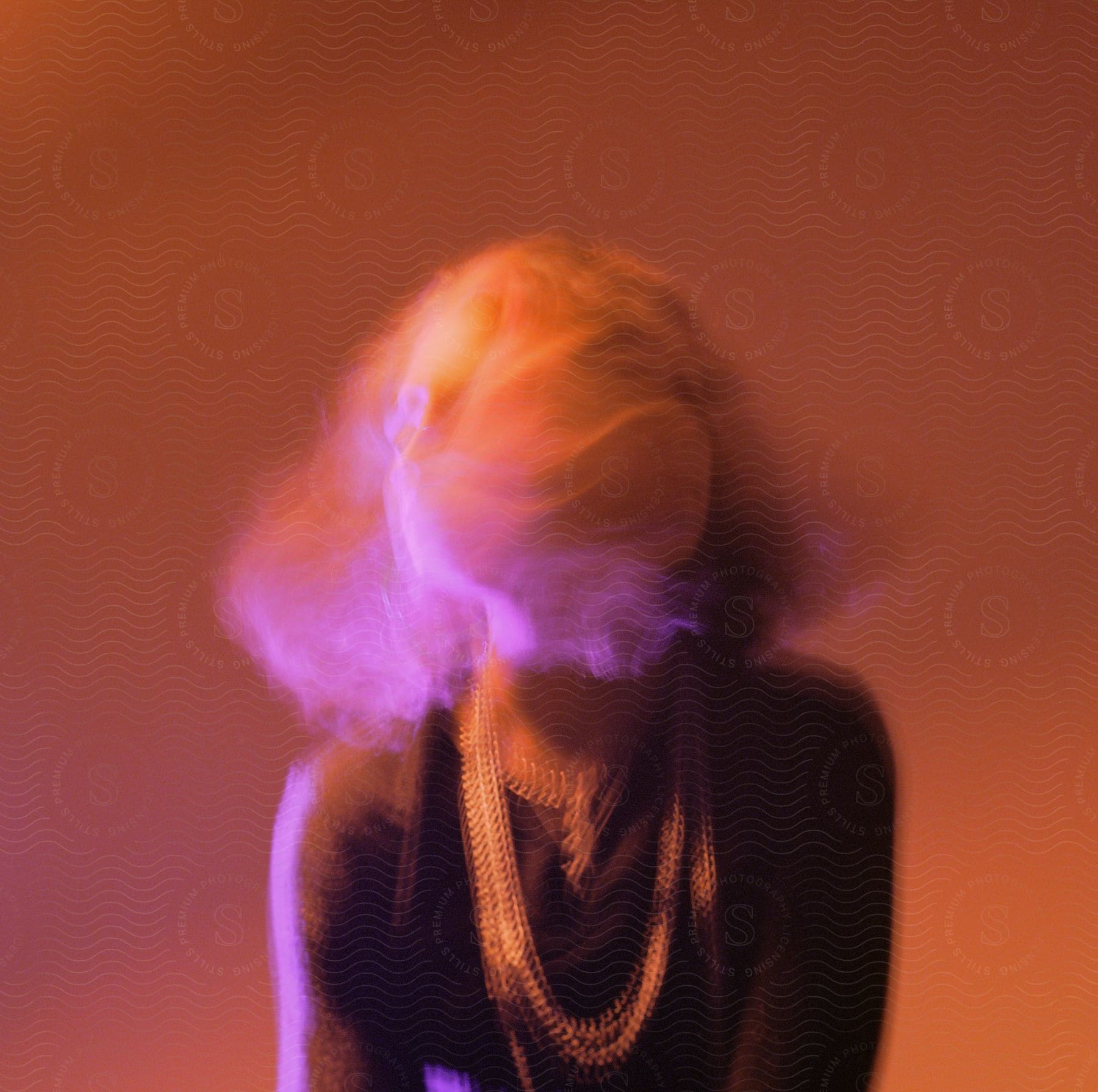 Blurred face of a woman sitting for a photograph with a substance