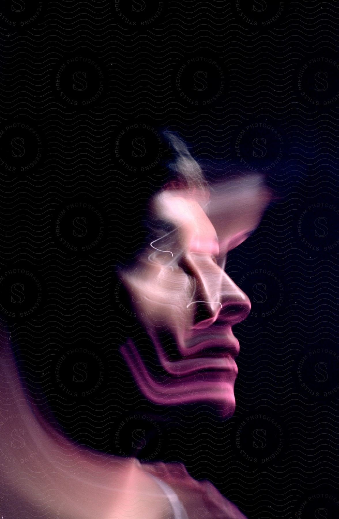 A persons face from profile distorted by motion blur