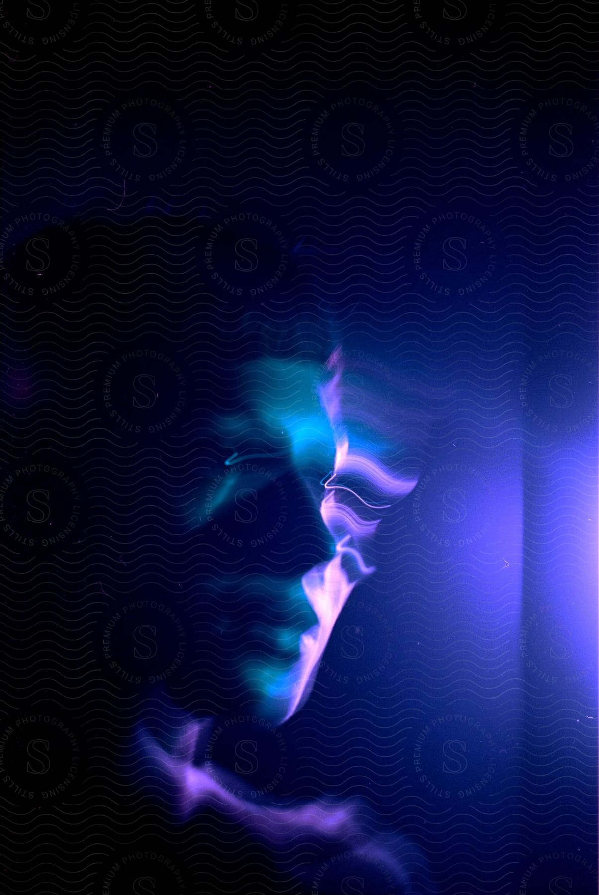 A persons face indoors distorted by blurry lights