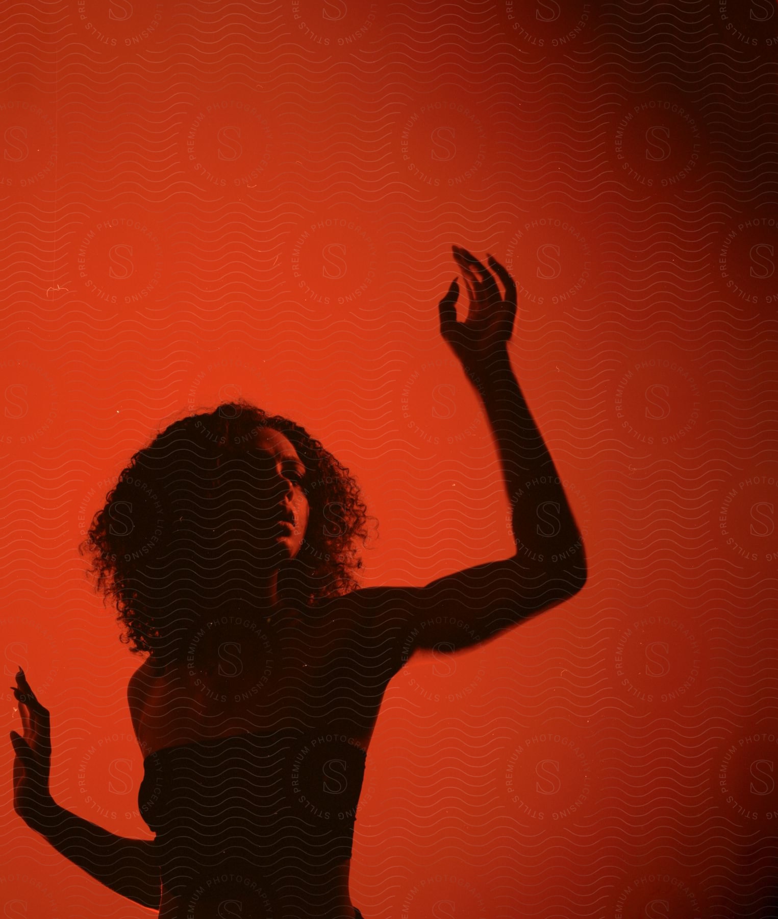 A happy woman with a silhouette raising her hand and showing a gesture