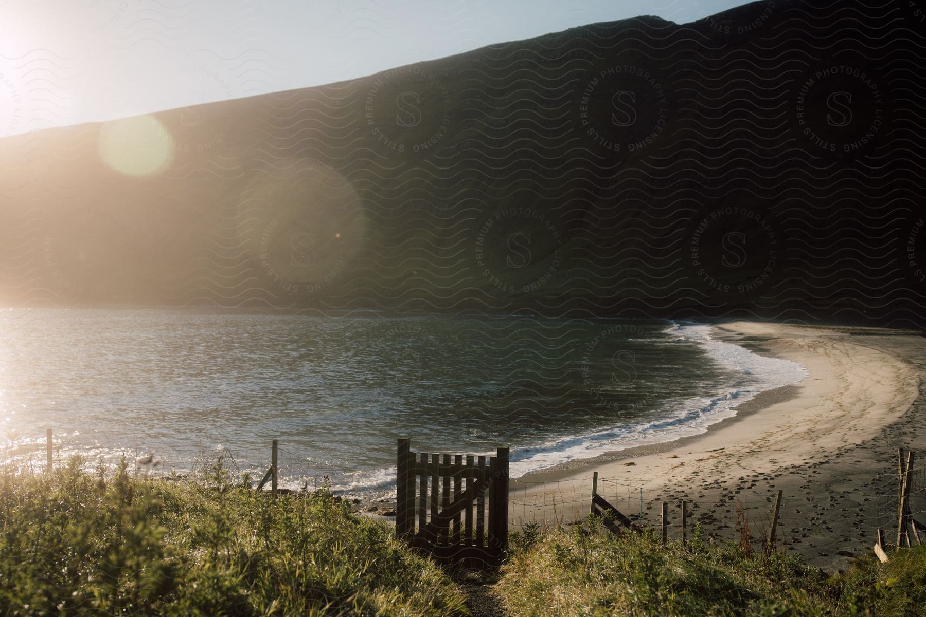 A Serene Coastal Landscape With Mountains And Water