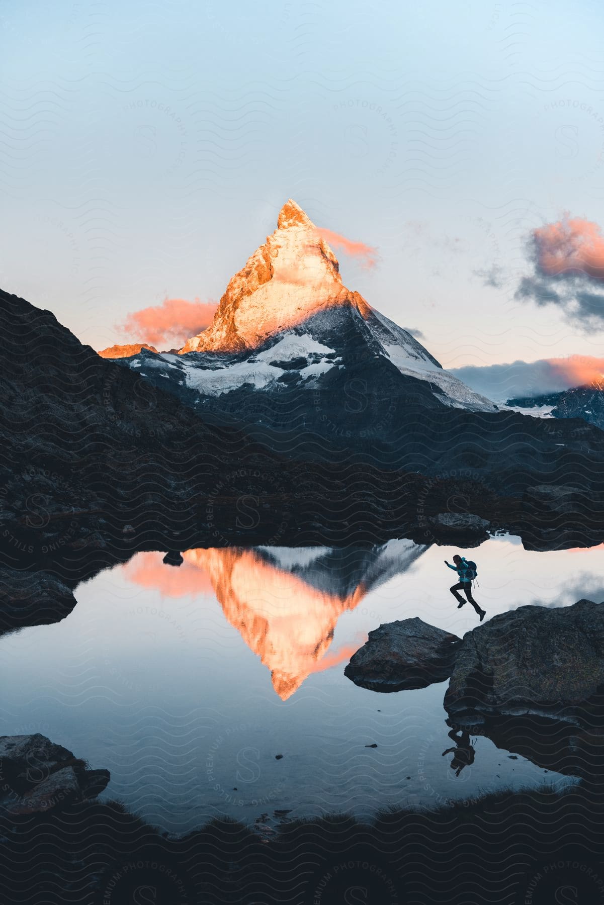 A serene landscape of a mountain peak reflected in a calm lake surrounded by wilderness