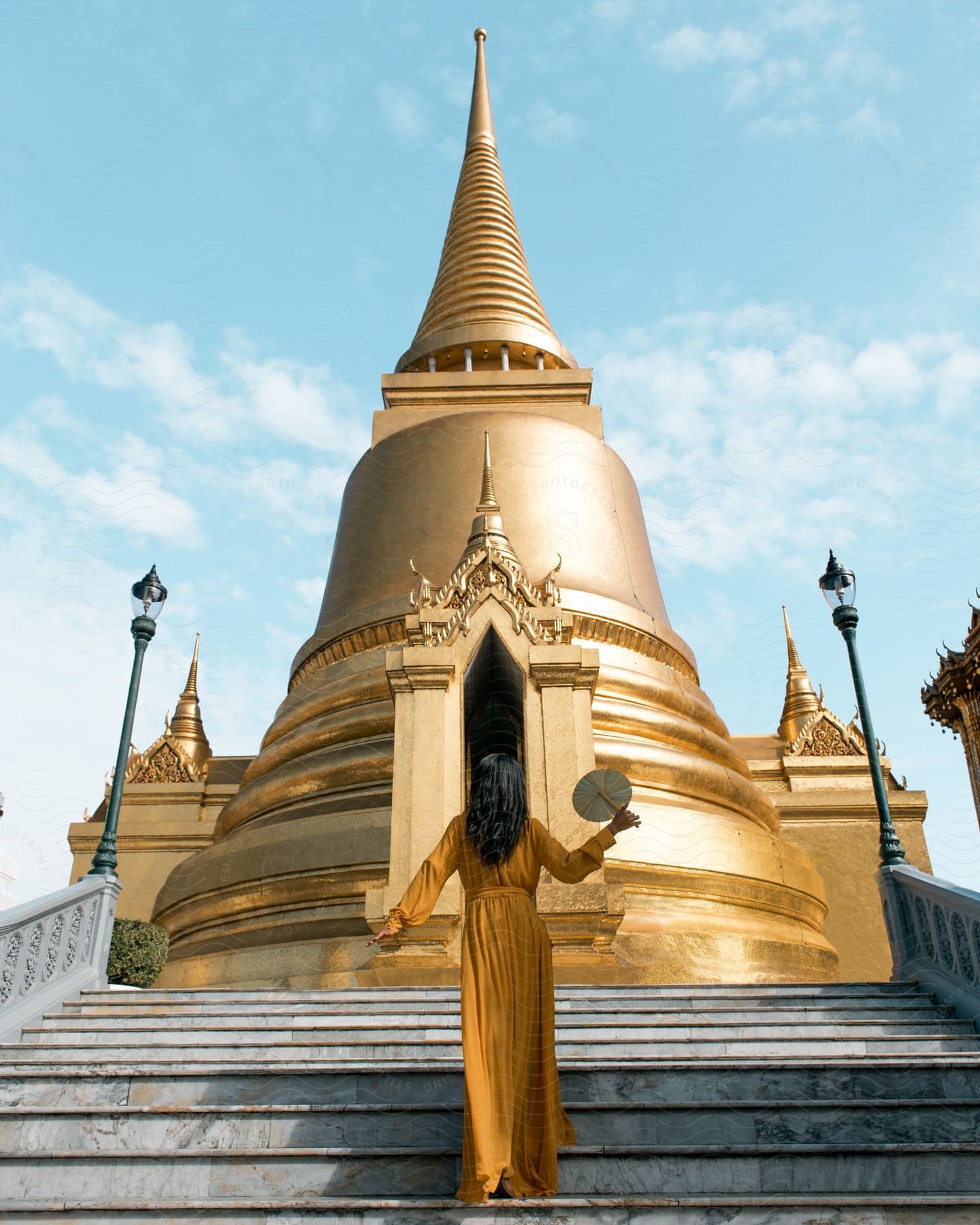 A woman standing near a temple in thailand