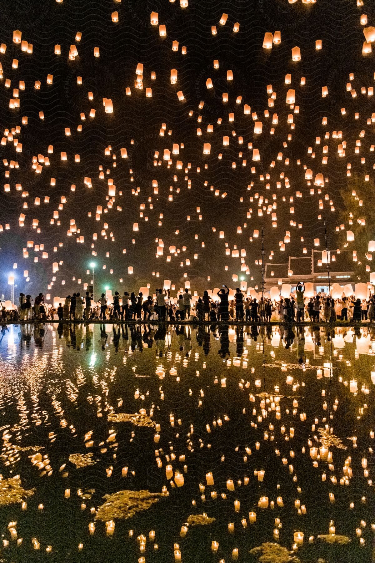 A large group of people releasing balloons at night