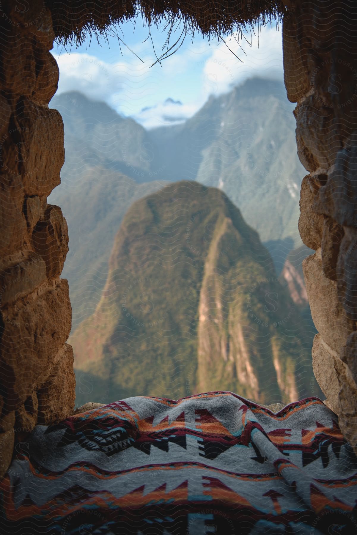 A stone window frames a mountain landscape