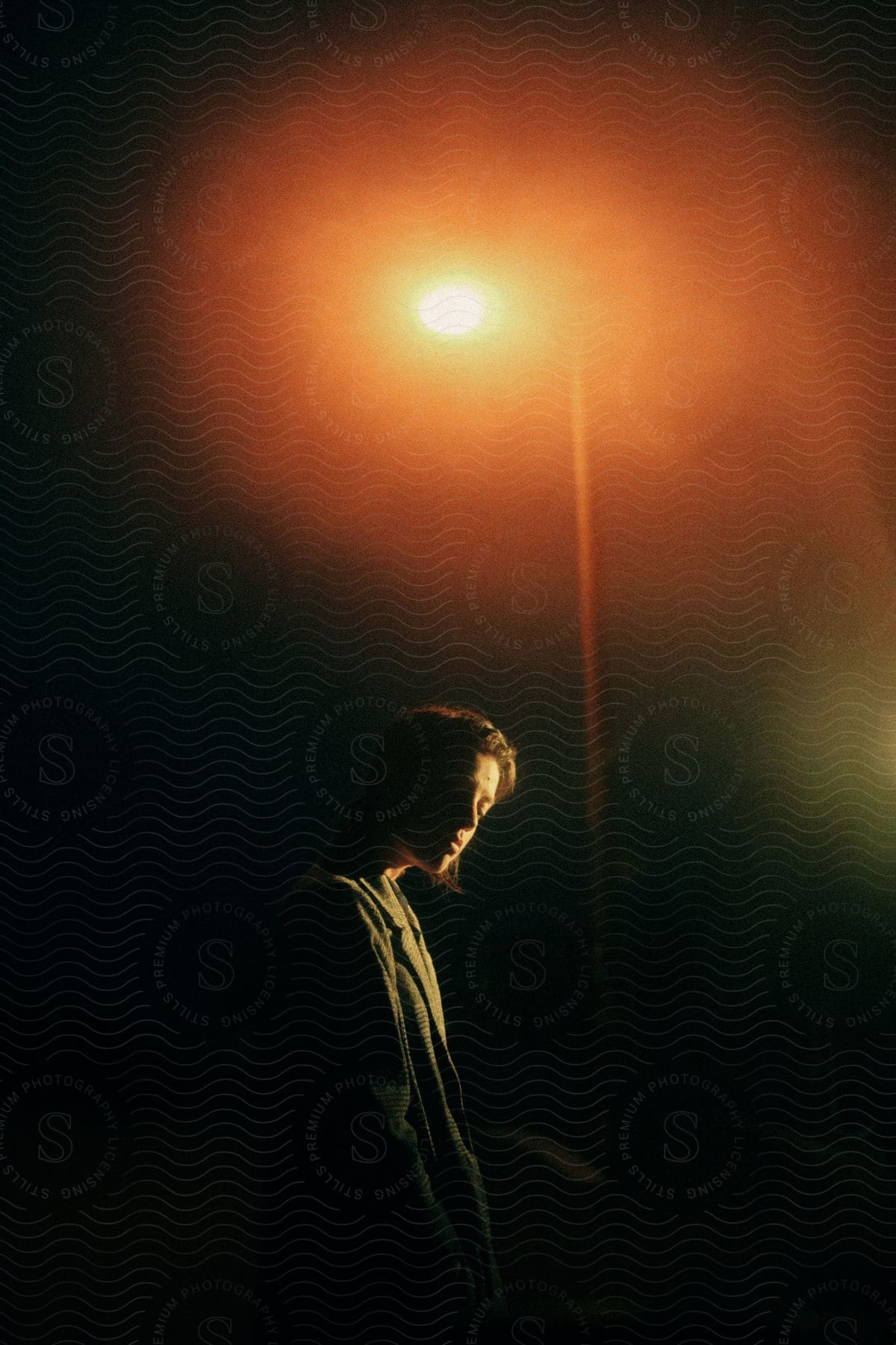 One person outdoors at night with a flash photography effect and a sky background