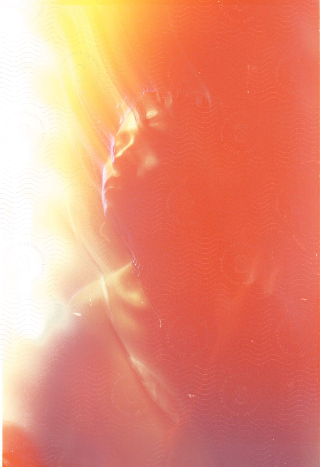 A Young Woman Is Seen Up Close Under Red And Yellow Trails Of Light Indoors