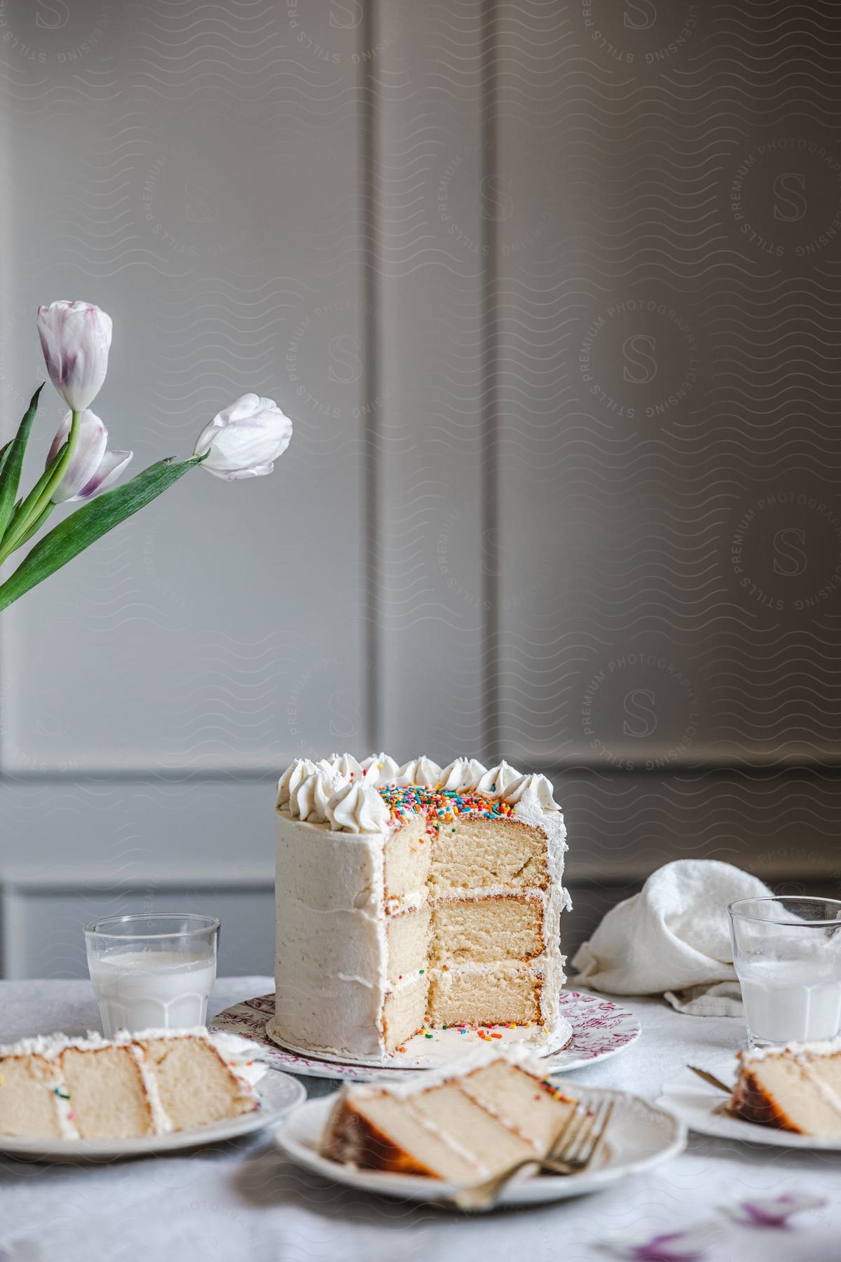 A neutral cake with flowers and cream