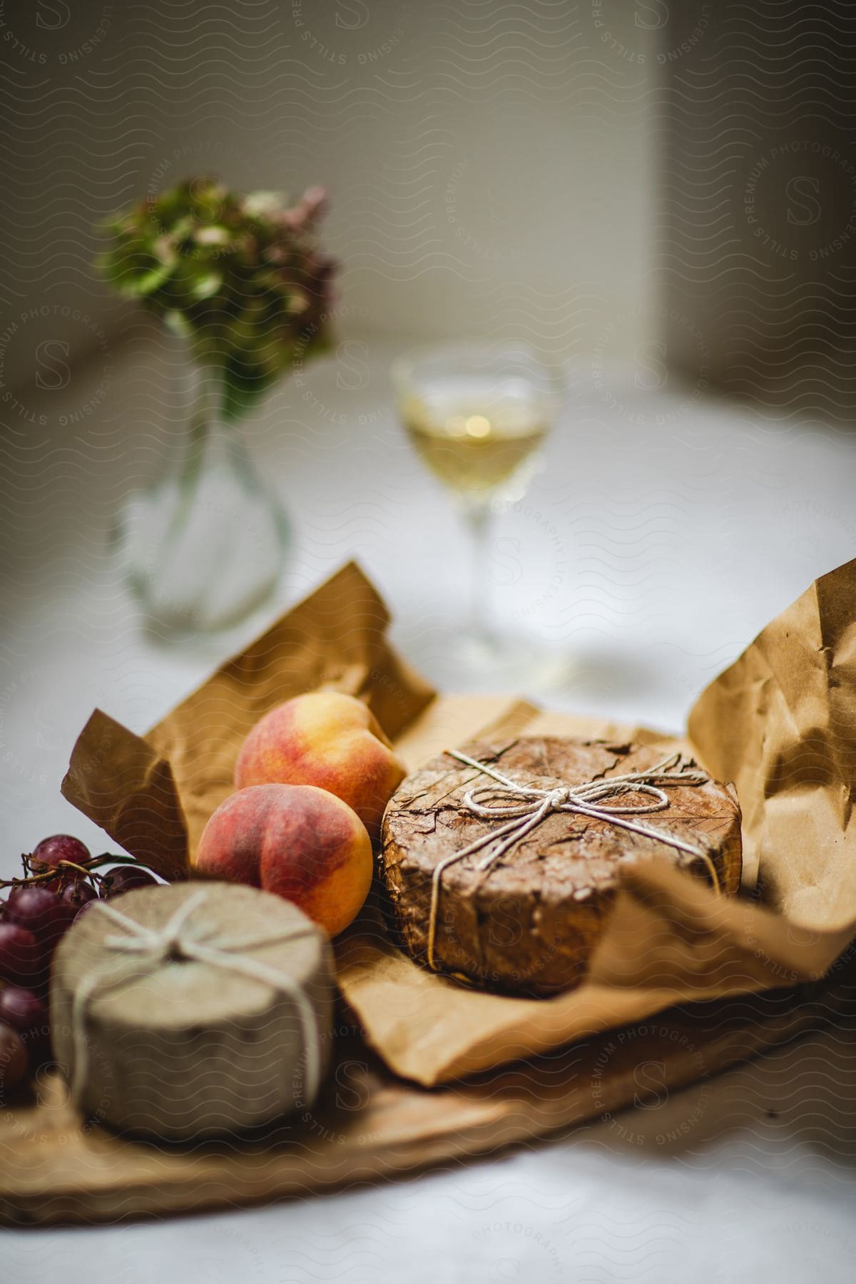 Wheels of cheese peaches and grapes on a tray