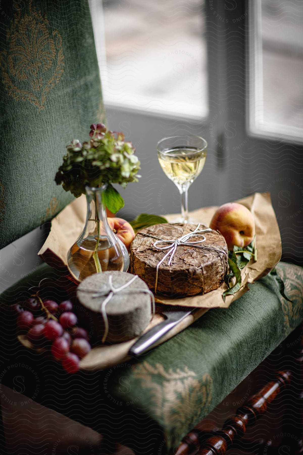 A food tray with fruit cheese and drink on a table