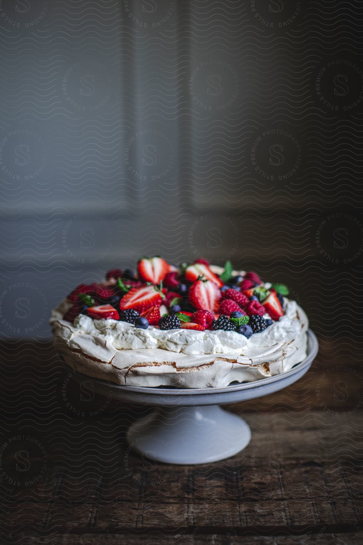 A neutral dish of strawberry cake with cream and fresh strawberries on a plate