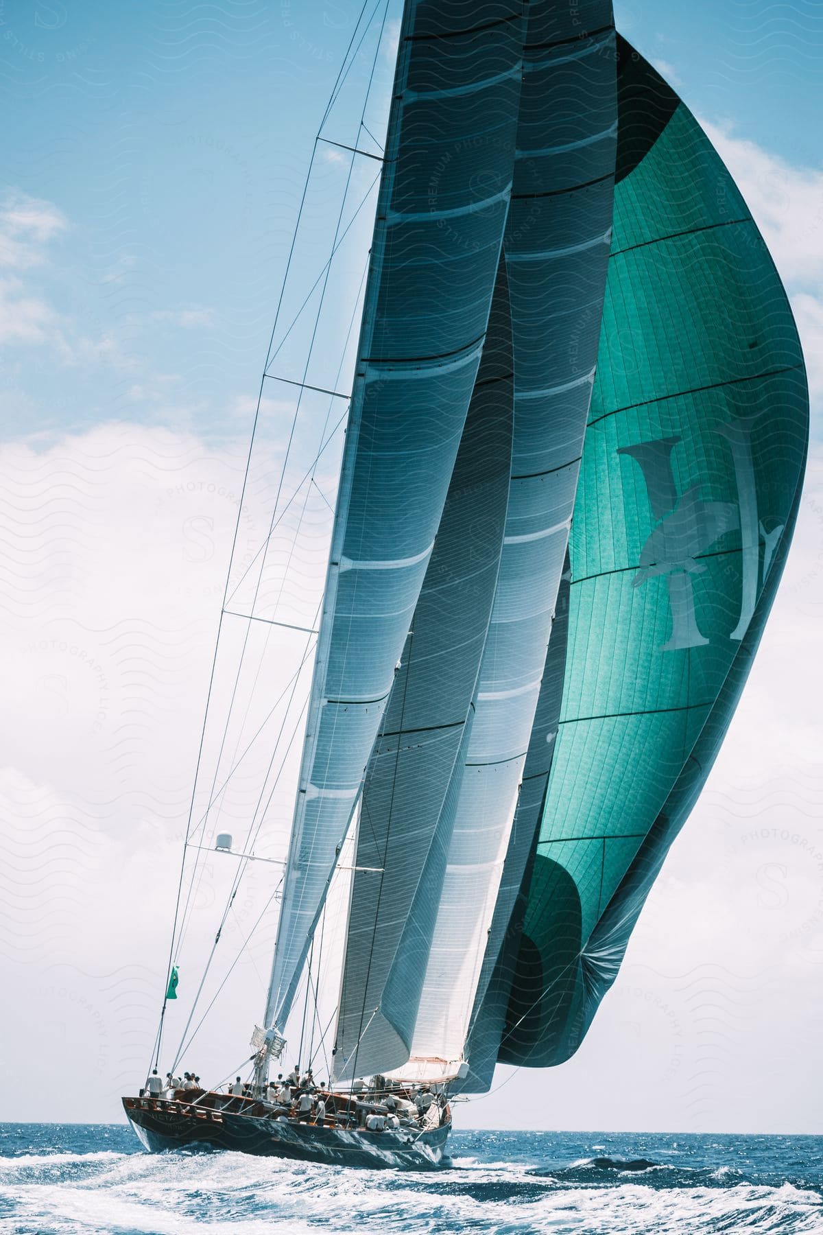 Sailing ship on blue waters under a blue sky