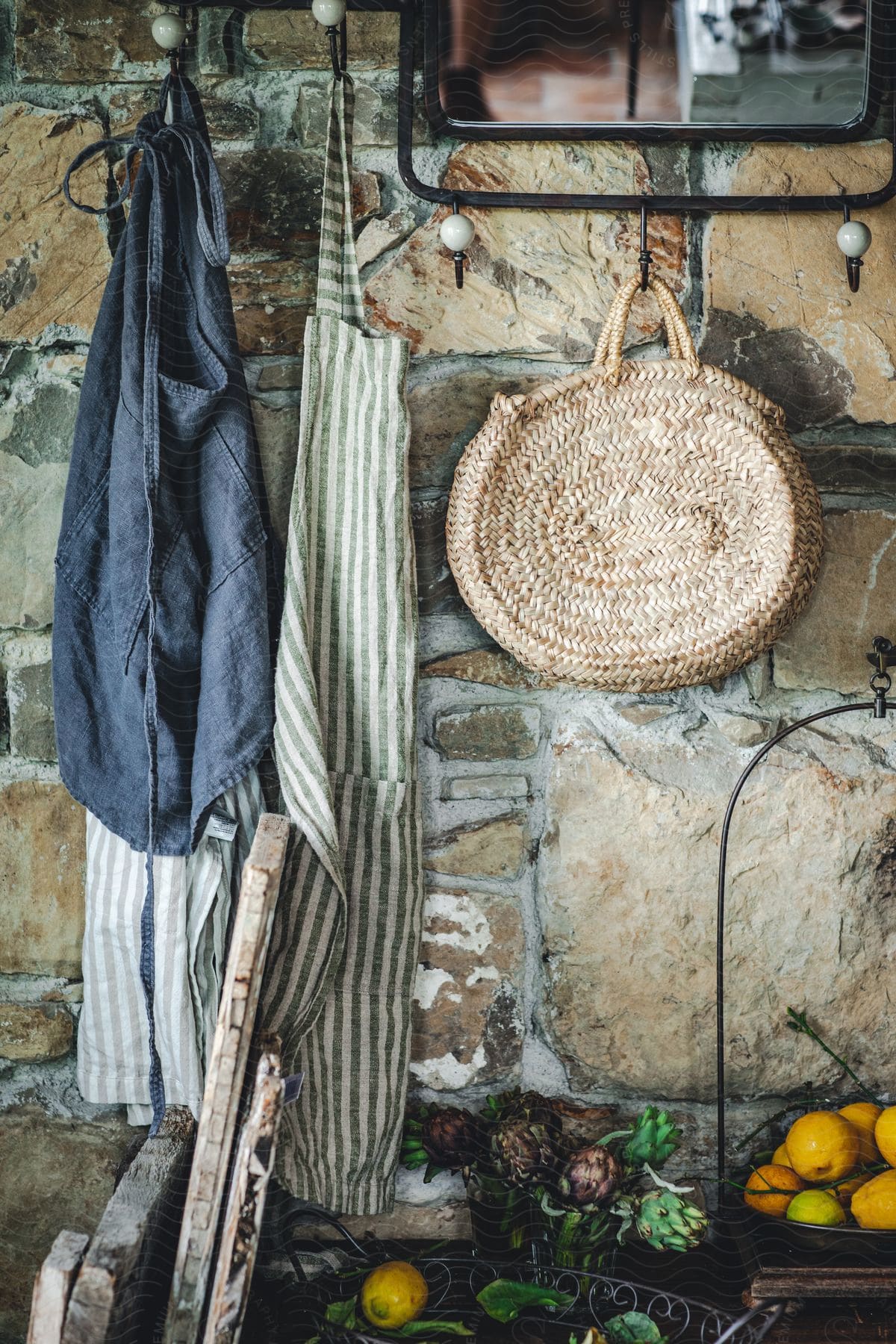 Aprons and baskets hanging from the wall in a rural kitchen