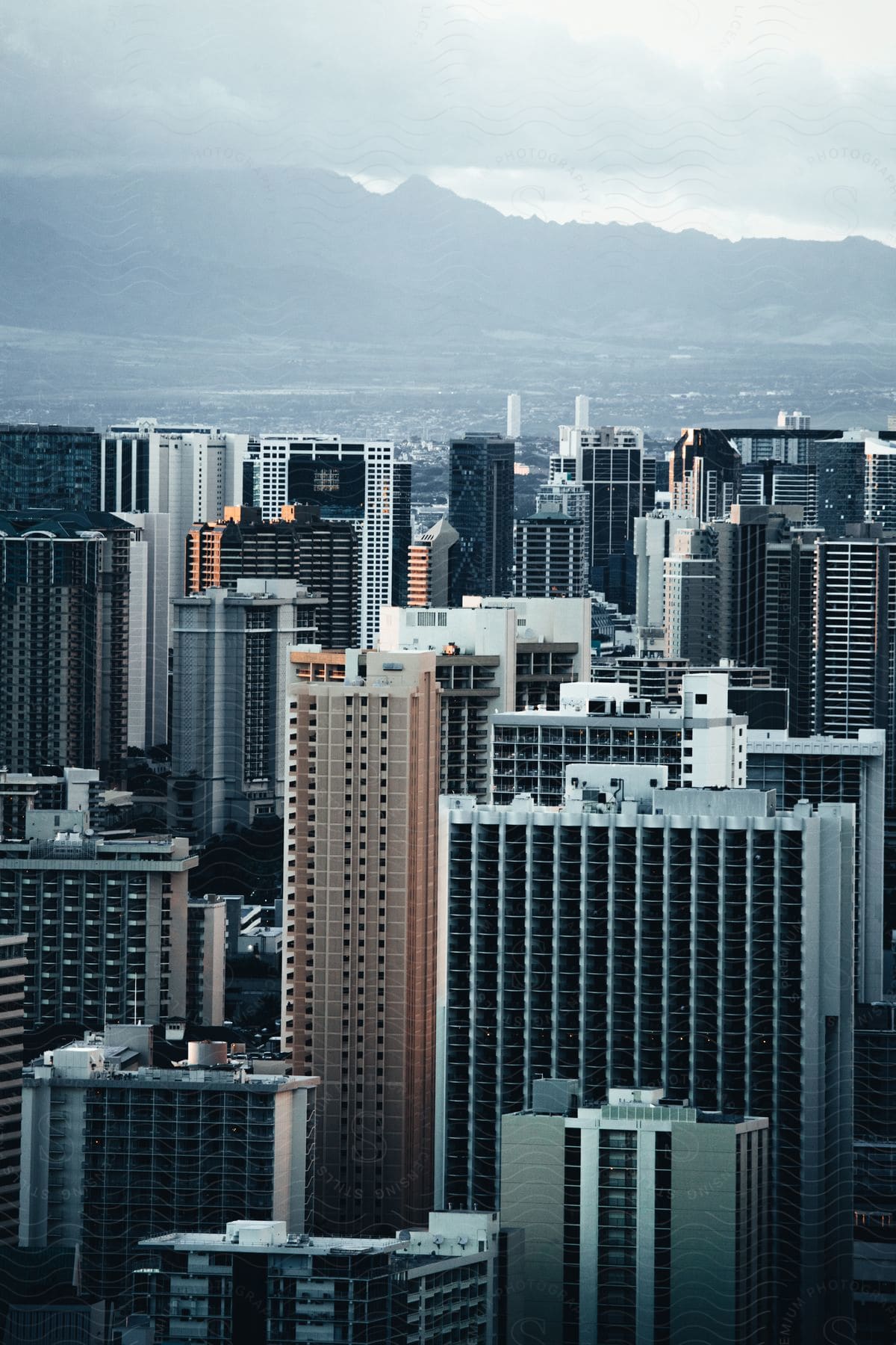 Urban cityscape with skyscrapers and highrise buildings against a cloudy sky