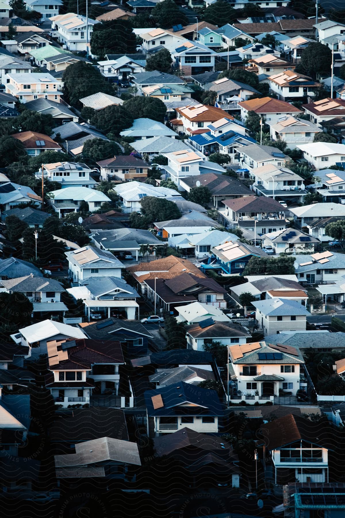 Aerial view of a suburban neighborhood with people and cars around the houses