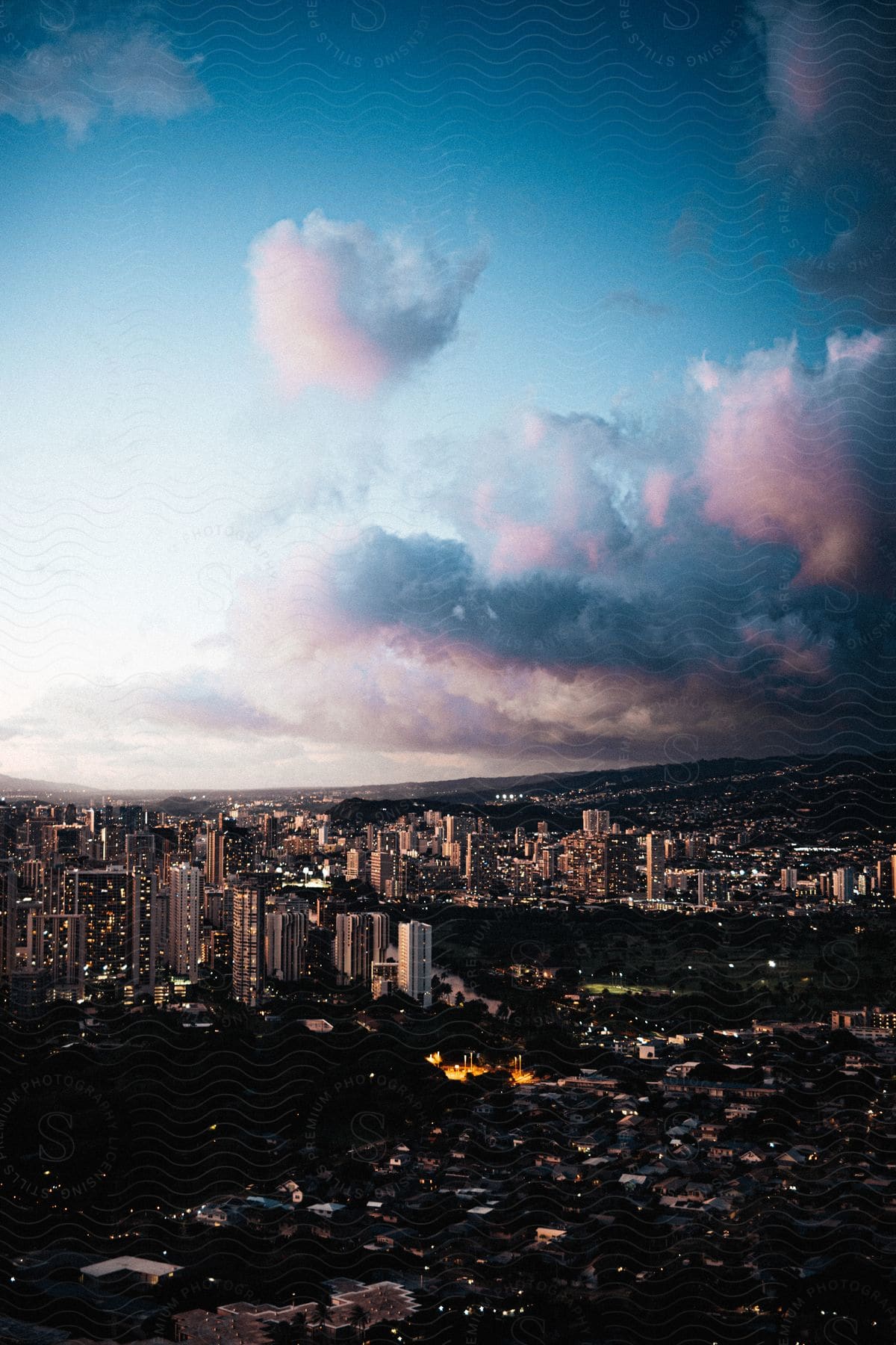 A vibrant cityscape with towering buildings against a colorful sky