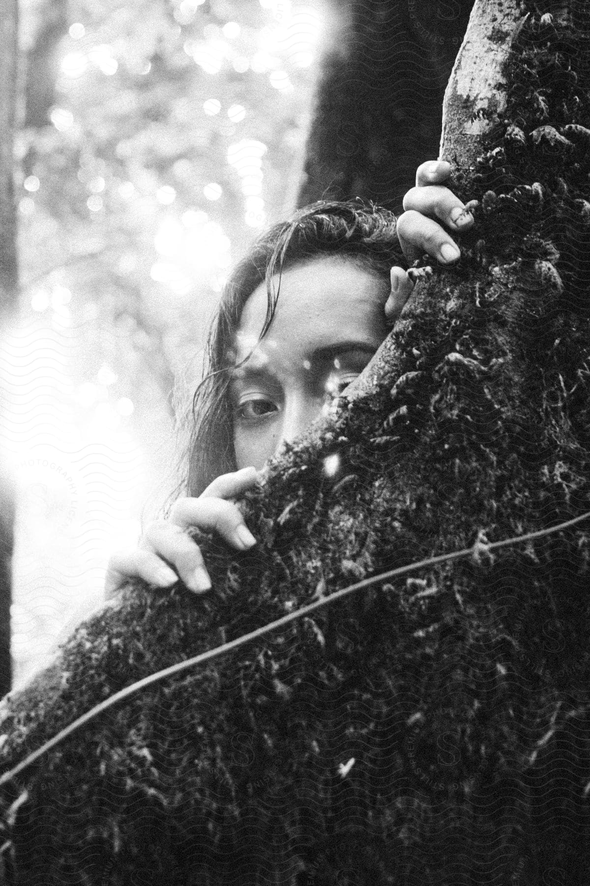 A woman with black hair hiding in the grass