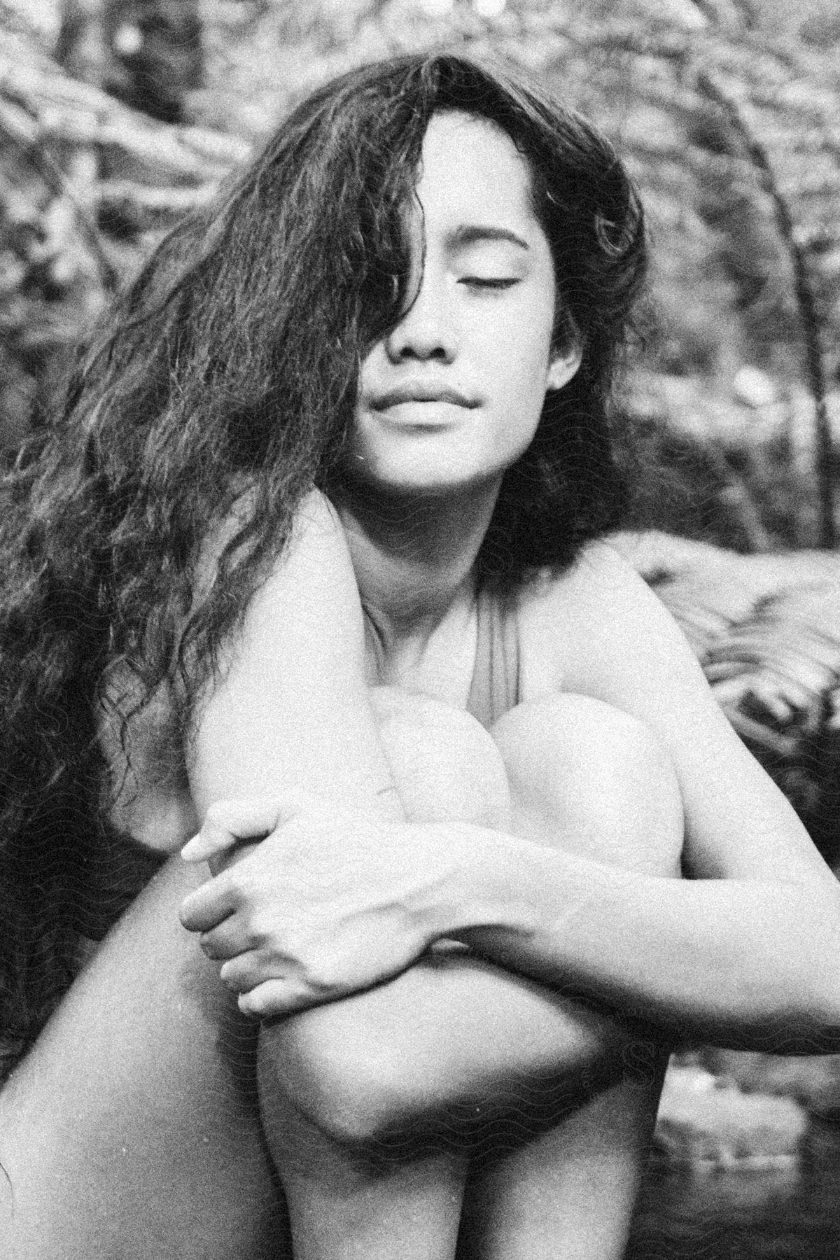 A contemplative woman with black hair in a blackandwhite photograph