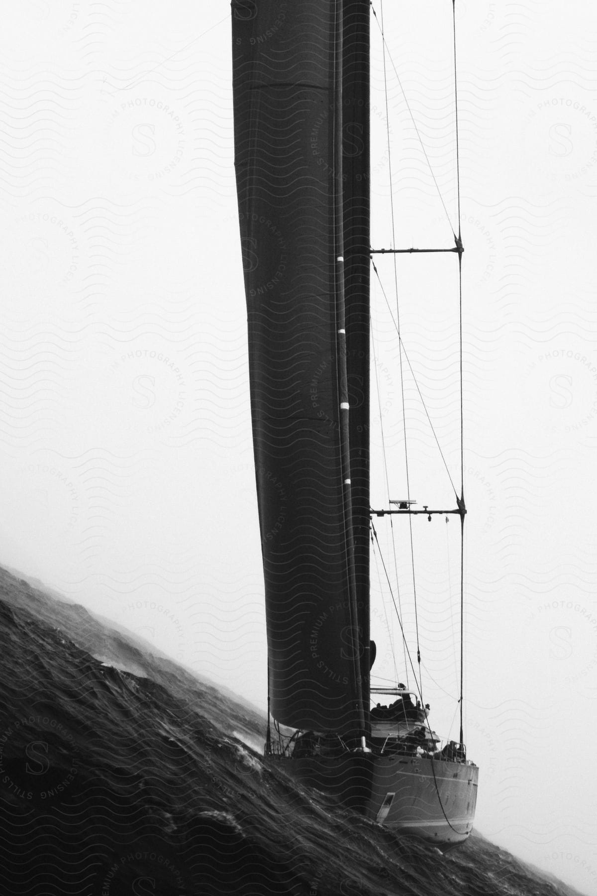 Yacht sail across water on cloudy day