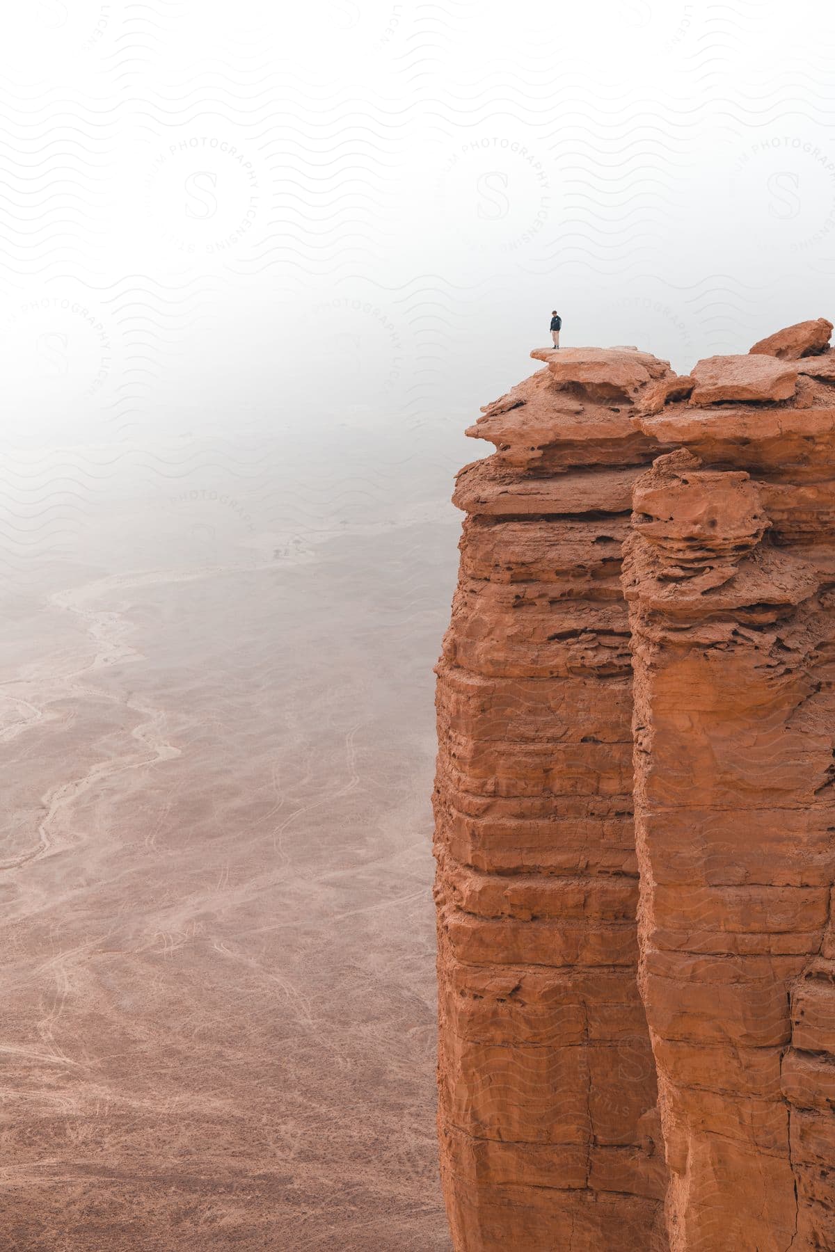 A person standing on a rock formation in saudi arabia