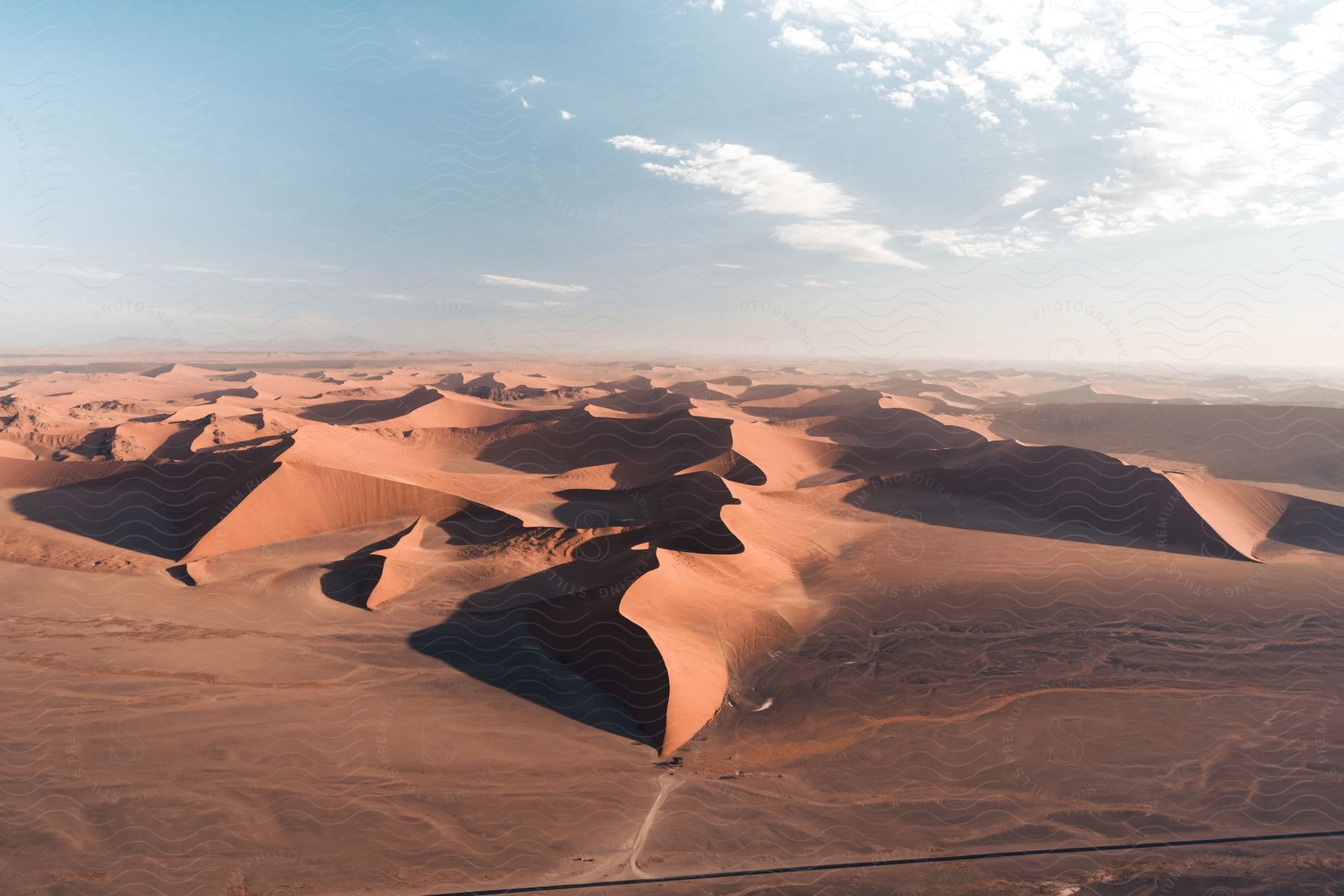 A barren desert landscape with a cloudy sky