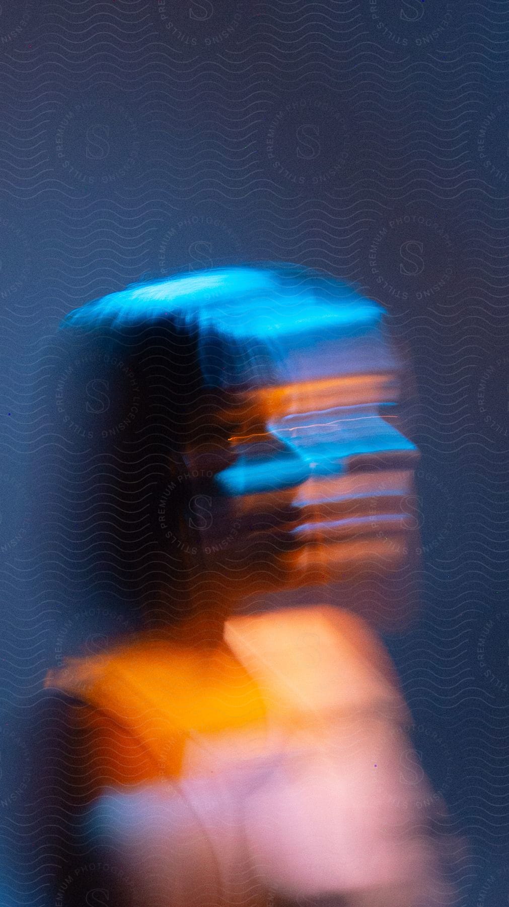 A blurred image of a woman in a room creating a mysterious and abstract composition